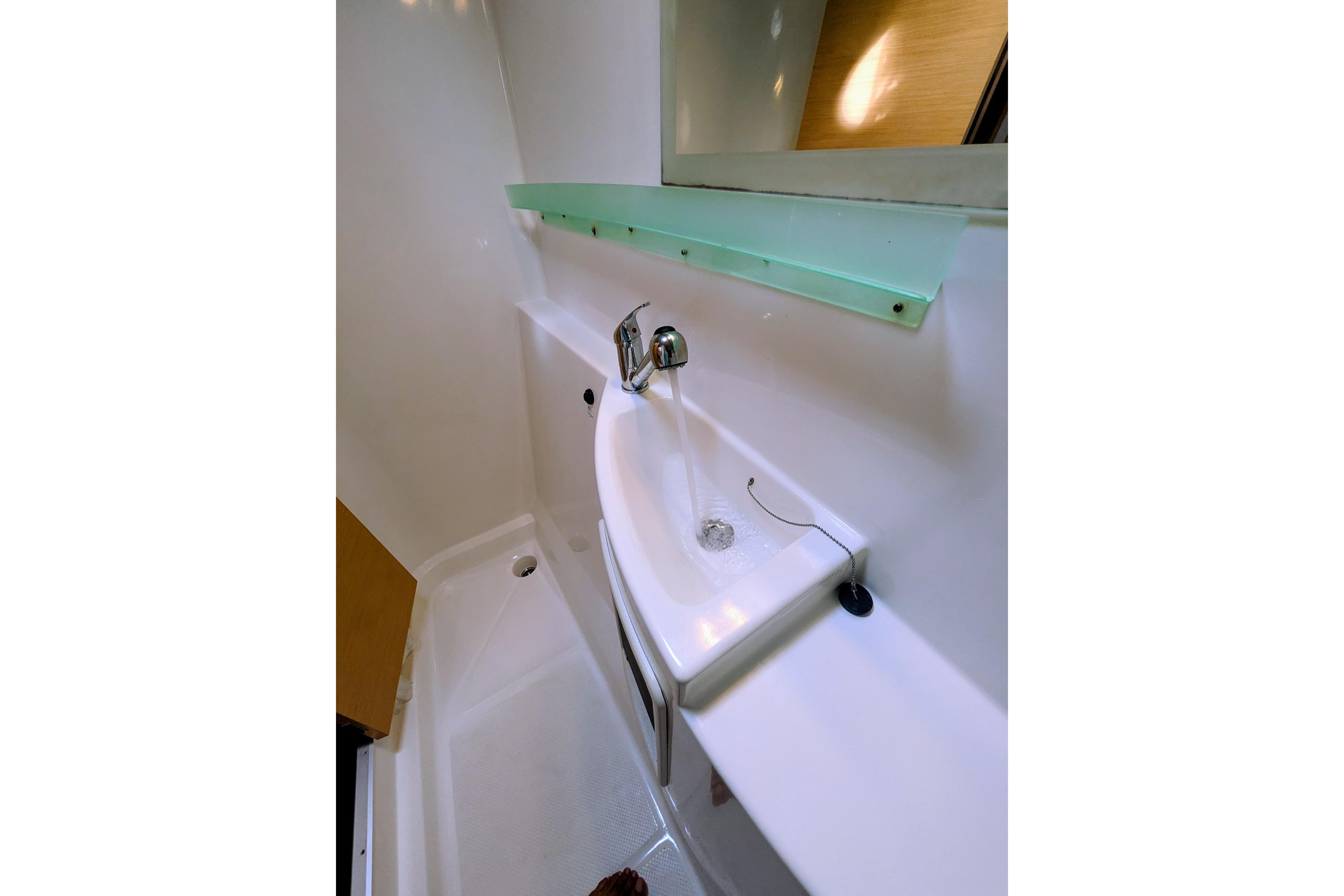 Bathroom sink area in 2012 Fountaine Pajot Lipari catamaran, featuring modern fixtures.