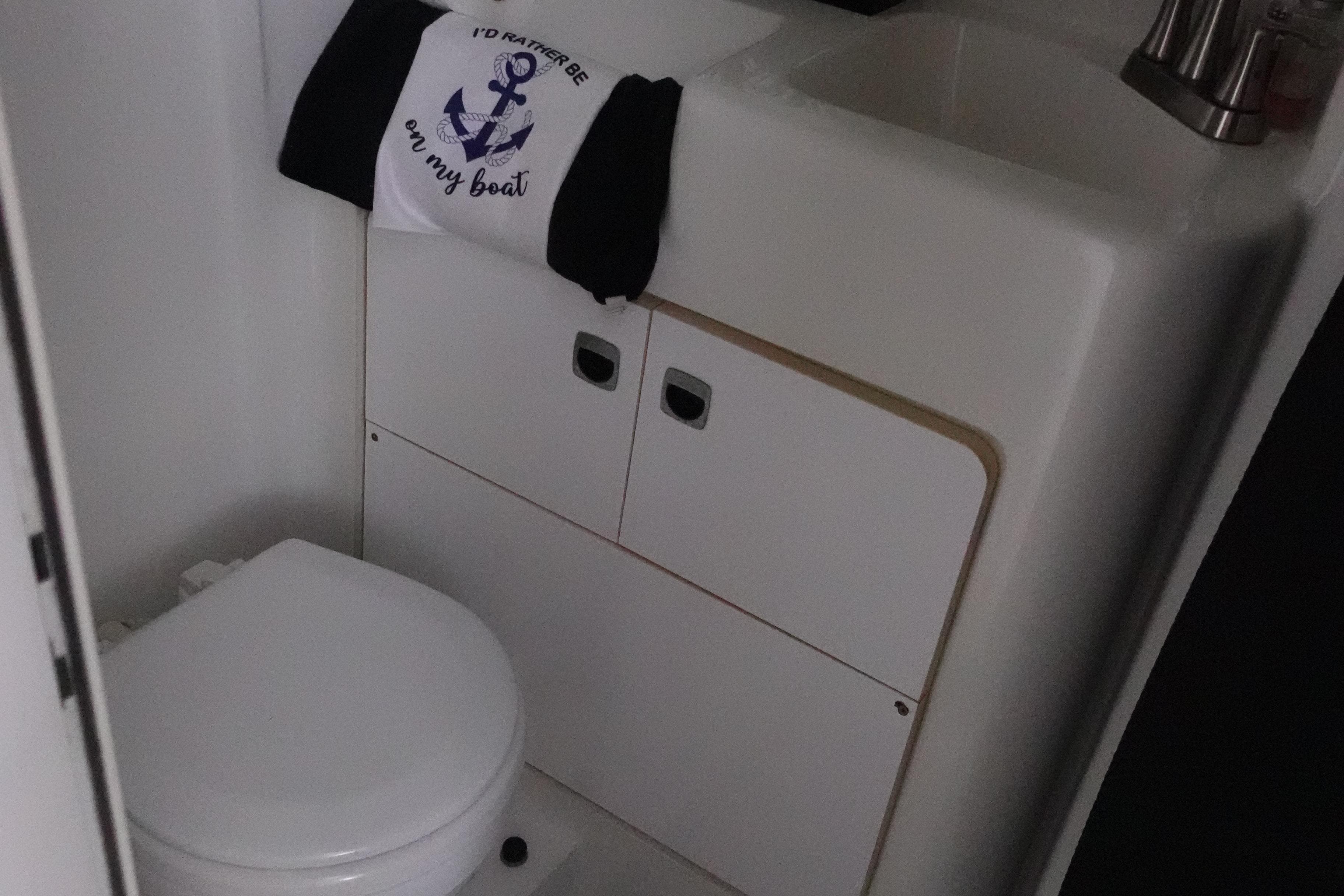 1993 Silverton 31 Convertible boat bathroom with toilet and sink.