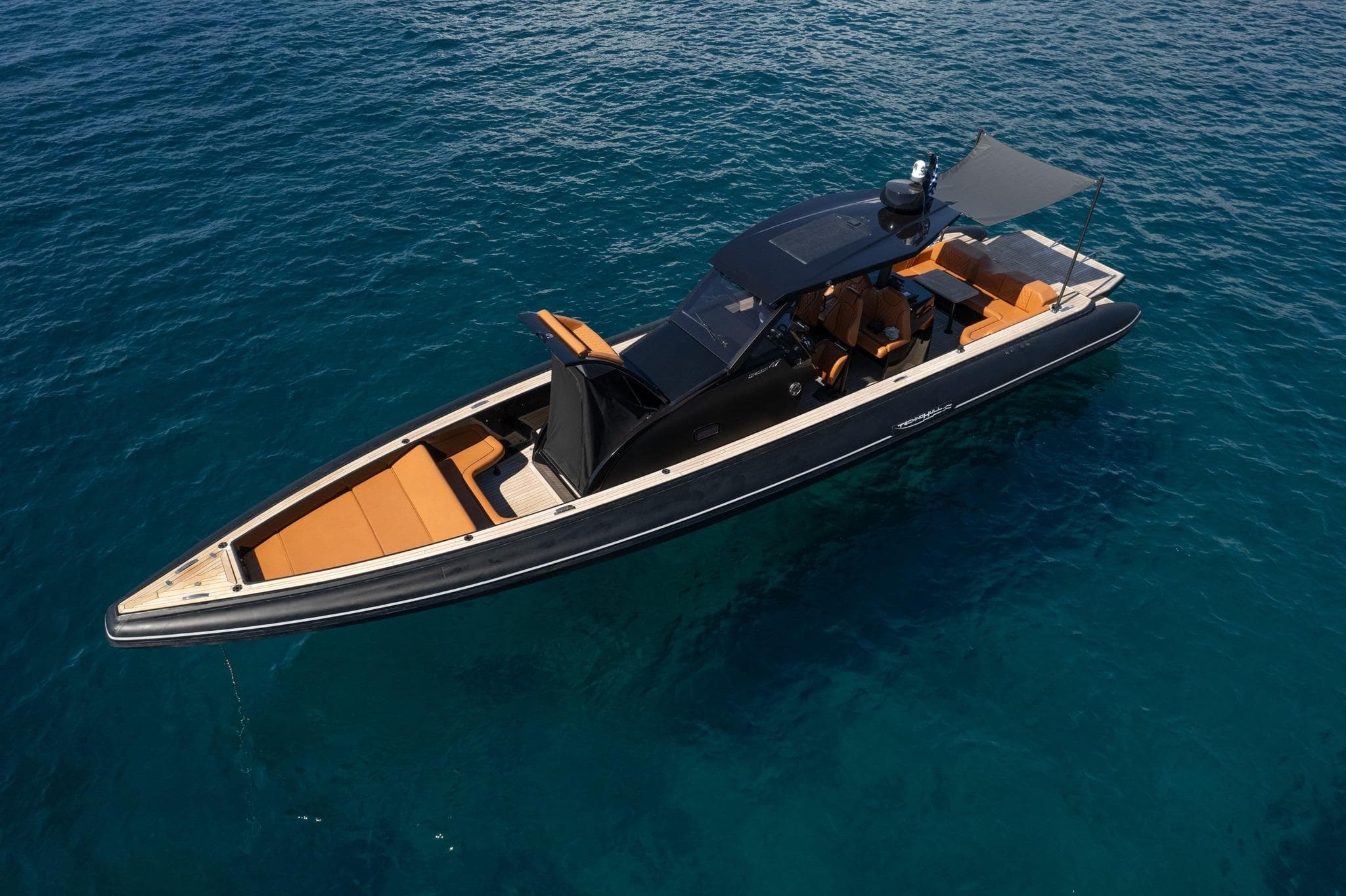 Technohull Omega 47 boat, 2021 model, cruising on clear blue water.