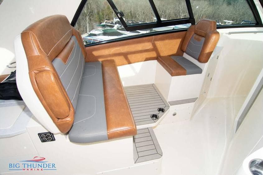 2022 Scout 350 LXZ boat interior with brown and gray seating, large windows.