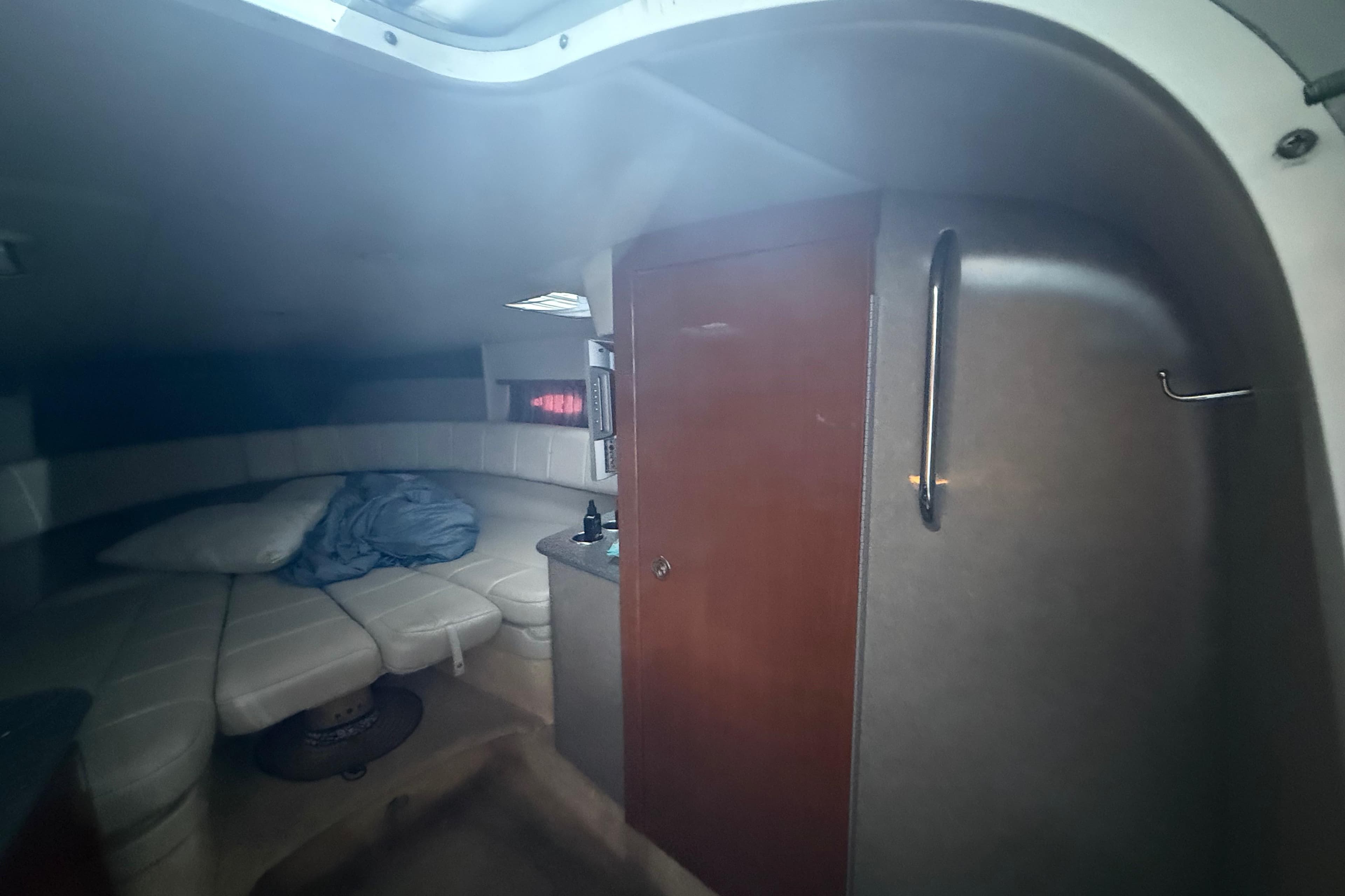 Interior cabin of 2005 Formula 330 Sun Sport boat with seating and storage.