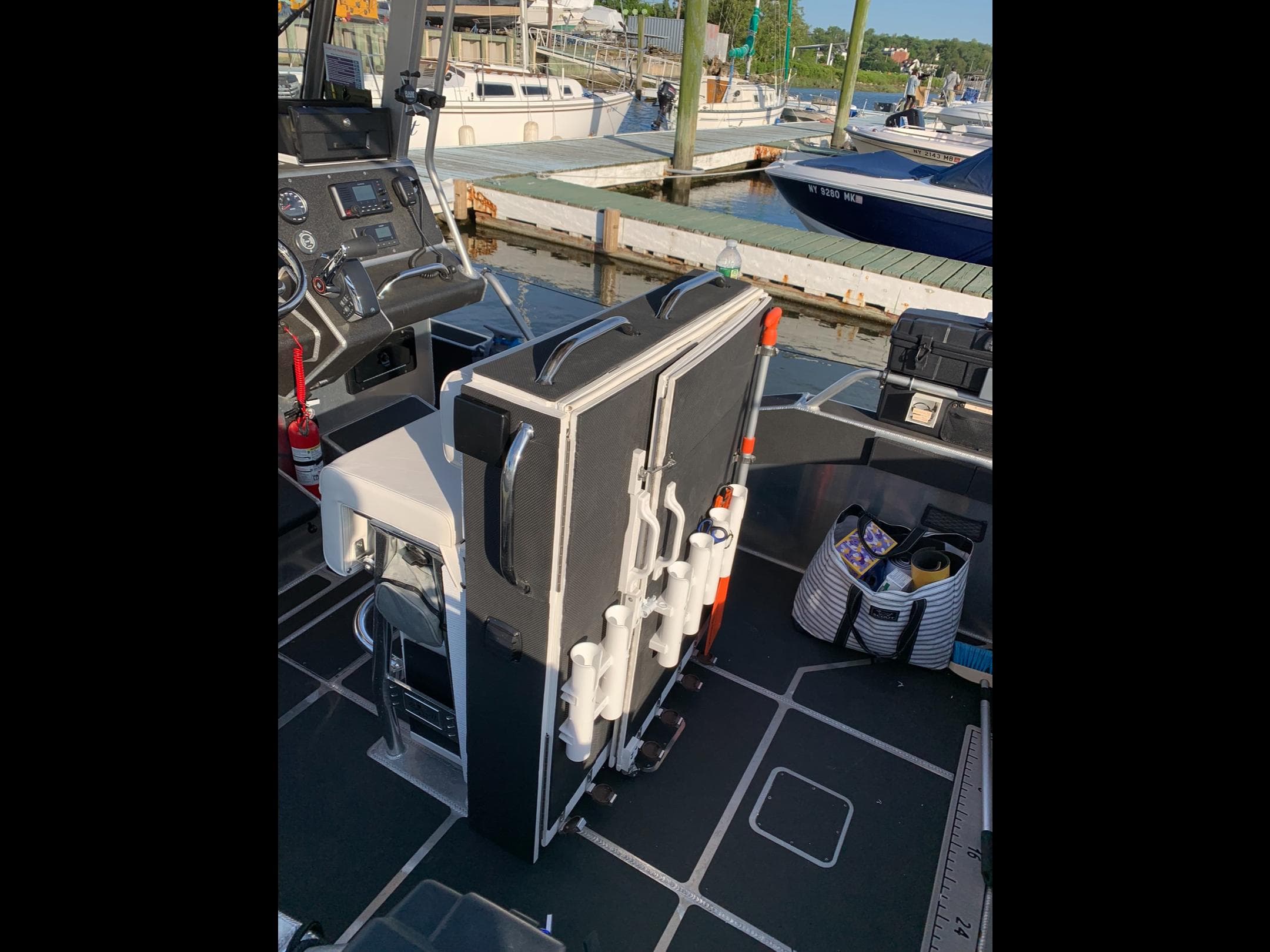 2023 Life Proof 21 Hard Top boat interior with equipment and dock view.