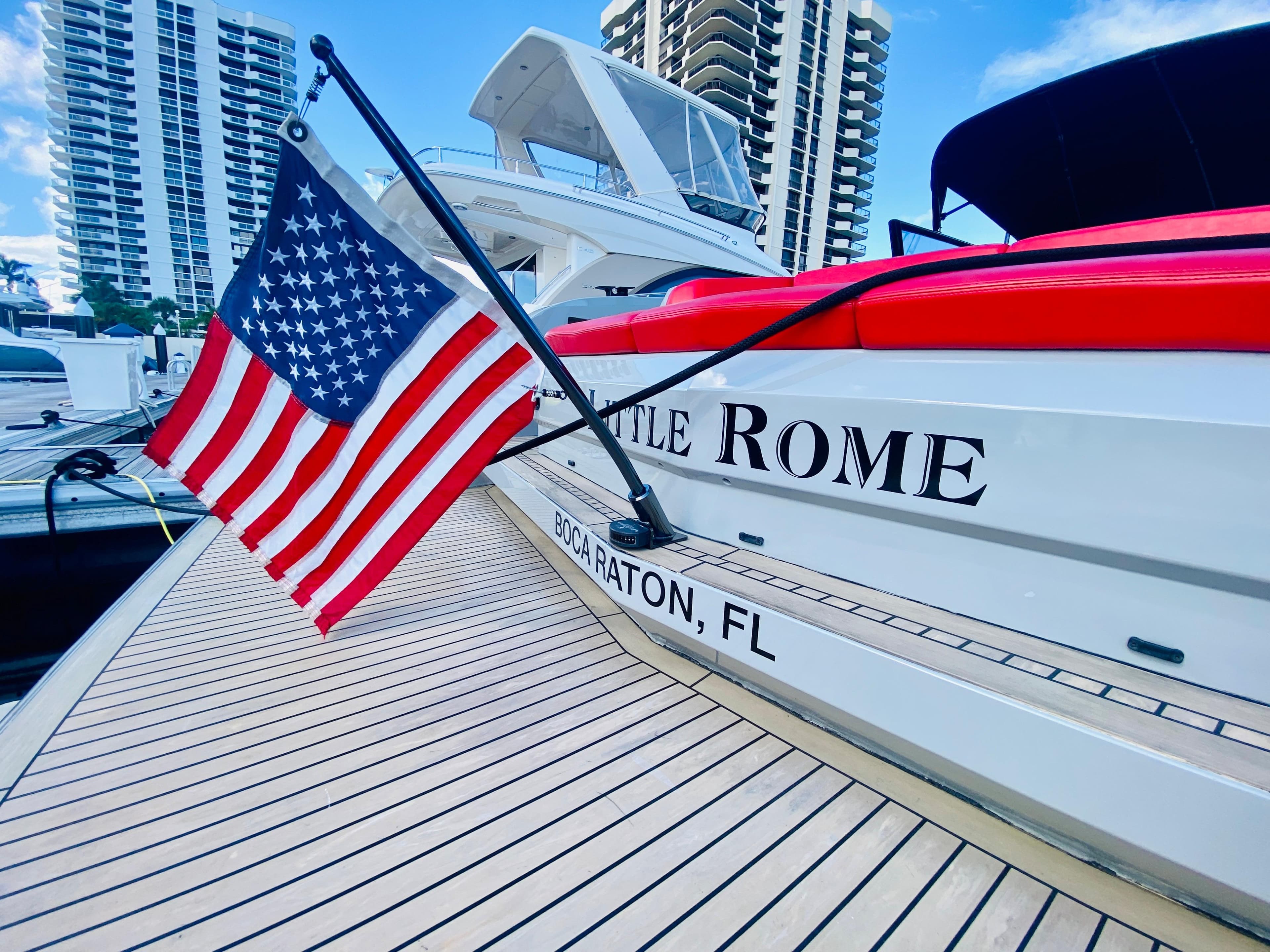 Vanquish VQ45 yacht docked, displaying American flag, Boca Raton, FL, 2020 model.