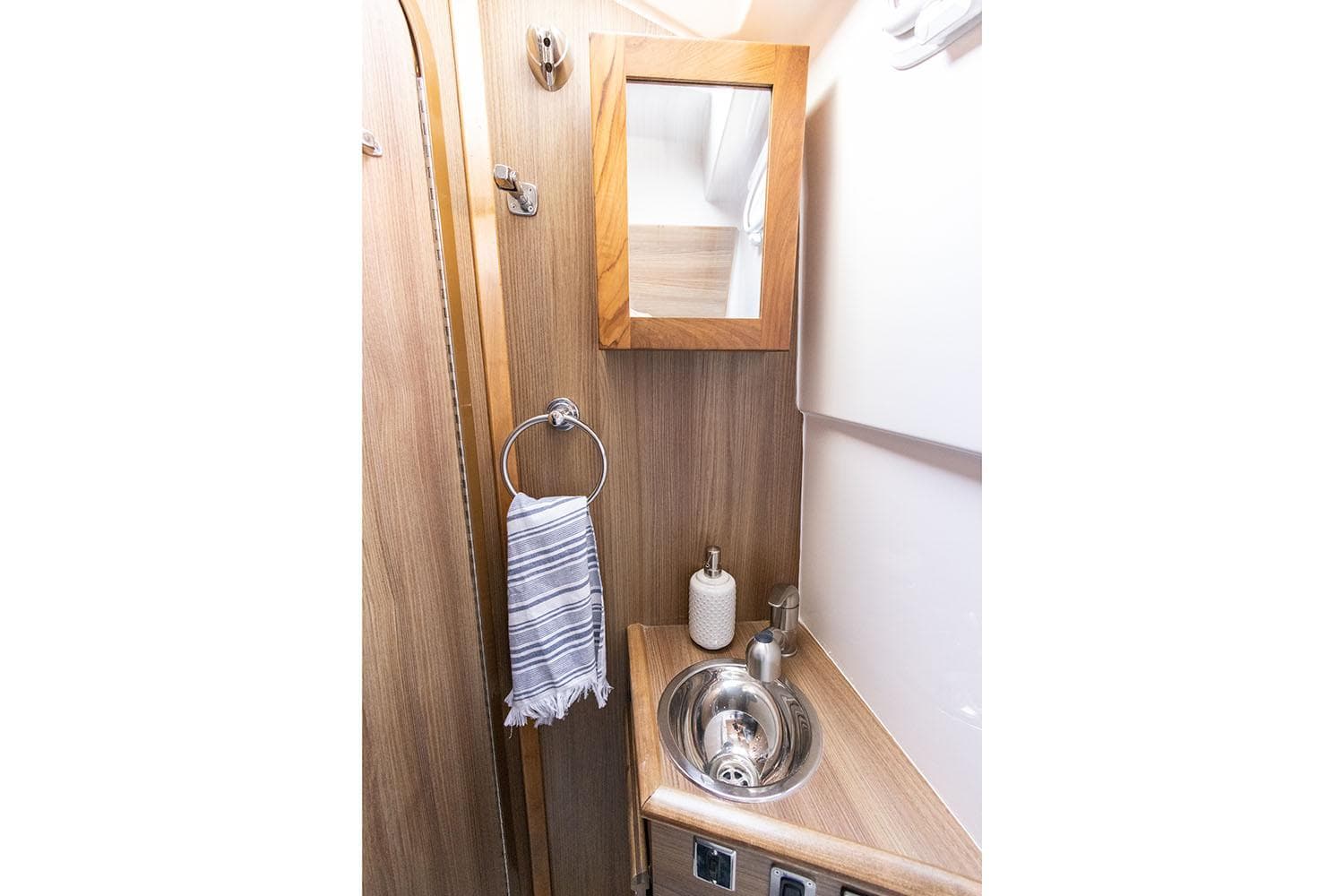 Manufacturer Provided Image: Compact bathroom in 2025 Solara S-310 CW with wood accents and stainless steel sink.