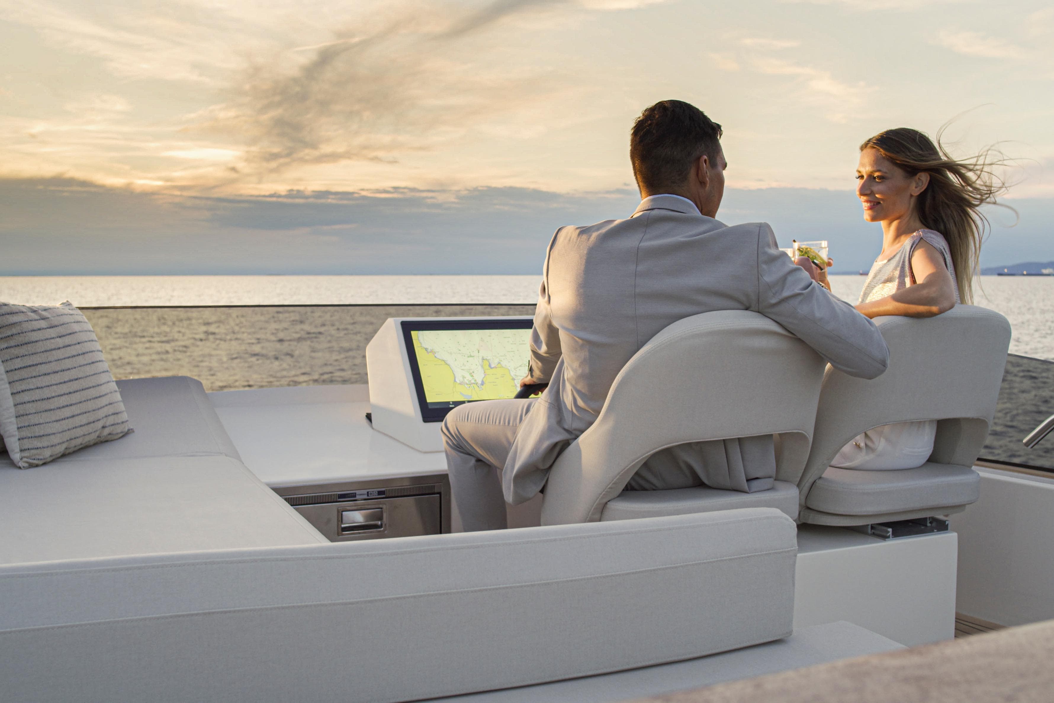 Couple enjoying sunset on Monachus 70 Fly yacht, 2026 model.