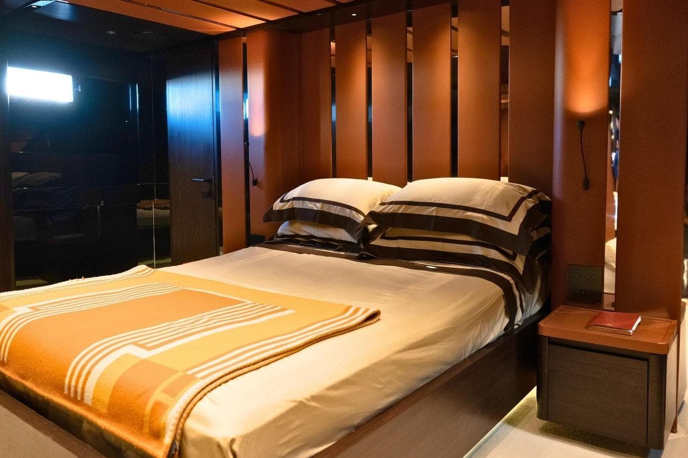 Luxurious bedroom interior on 2008 Magnum 80 yacht, featuring elegant bedding and warm lighting.