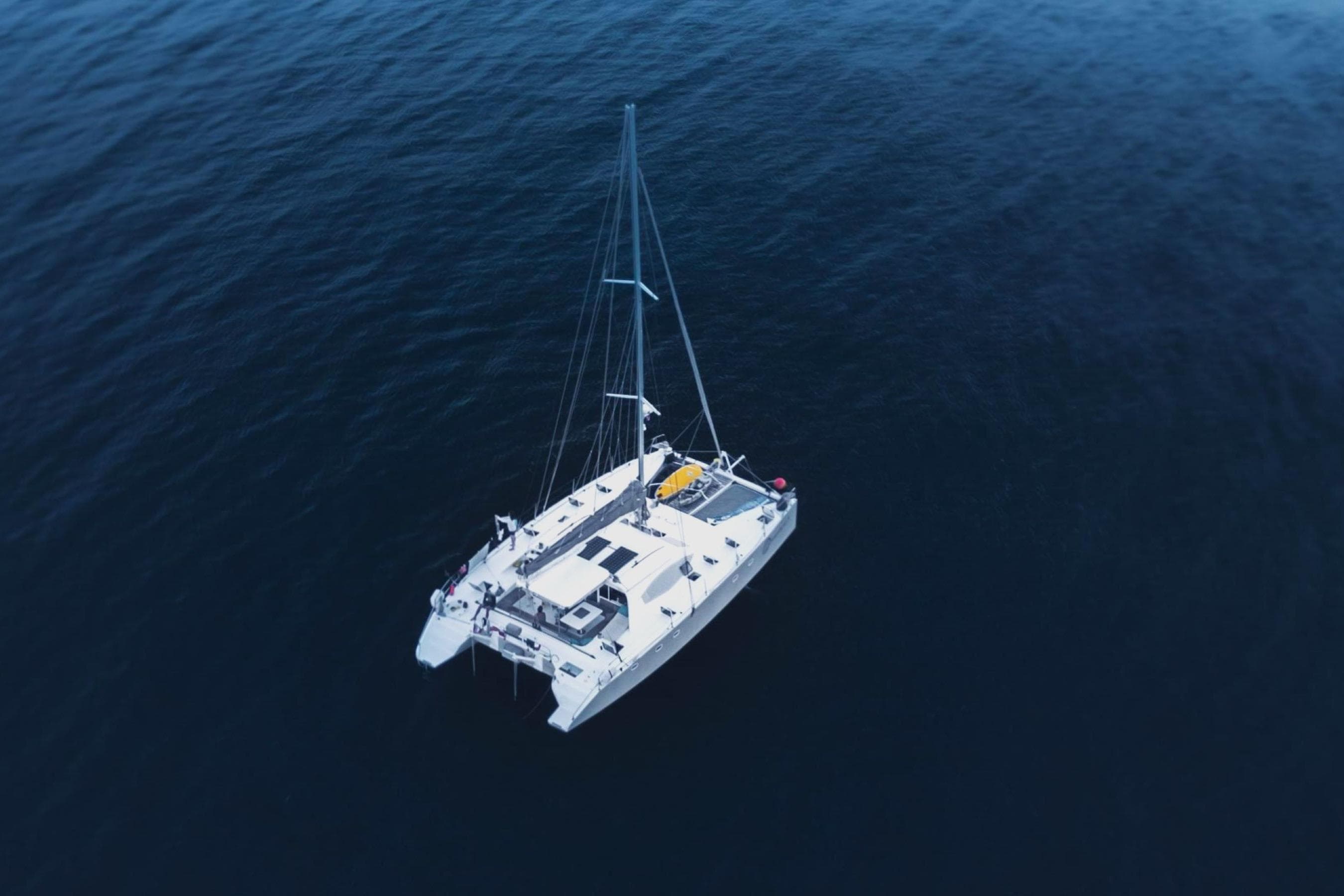 Aerial view of 2003 Multicap Caraibes PUNCH 1500 LC catamaran on open sea.
