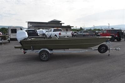 2025 Lowe Roughneck 1860 Rambler boat on trailer in parking lot.