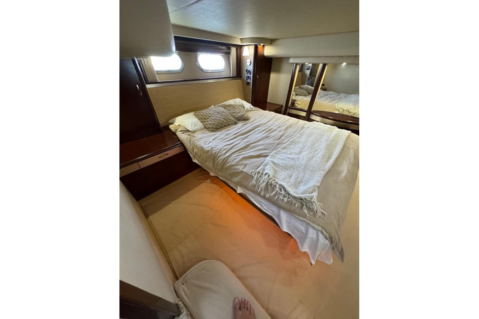Luxurious bedroom interior of 2005 Sea Ray 580 Sedan Bridge yacht with cozy bedding.