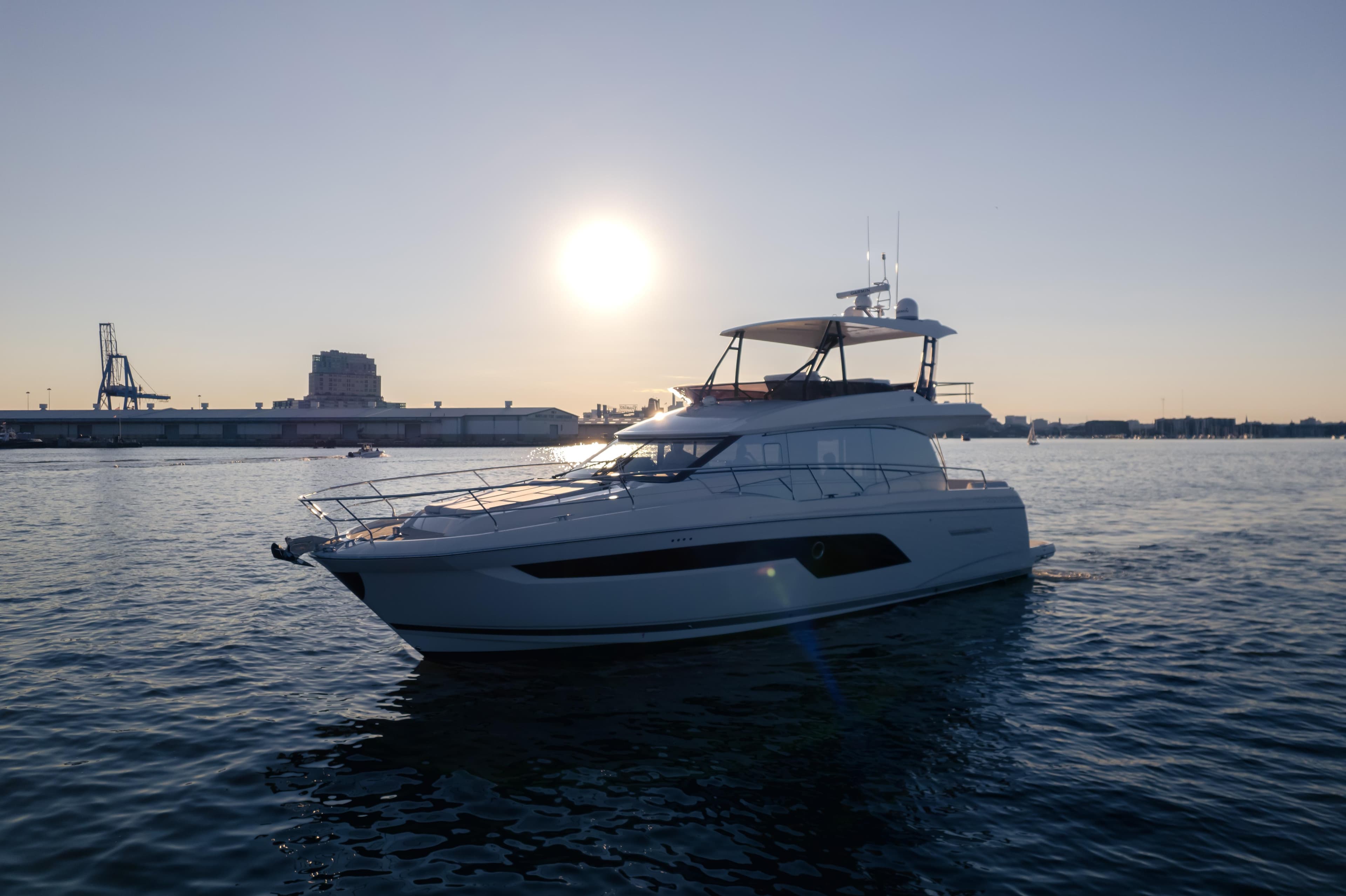 Luxury yacht Prestige 520 from 2026 on water at sunset.