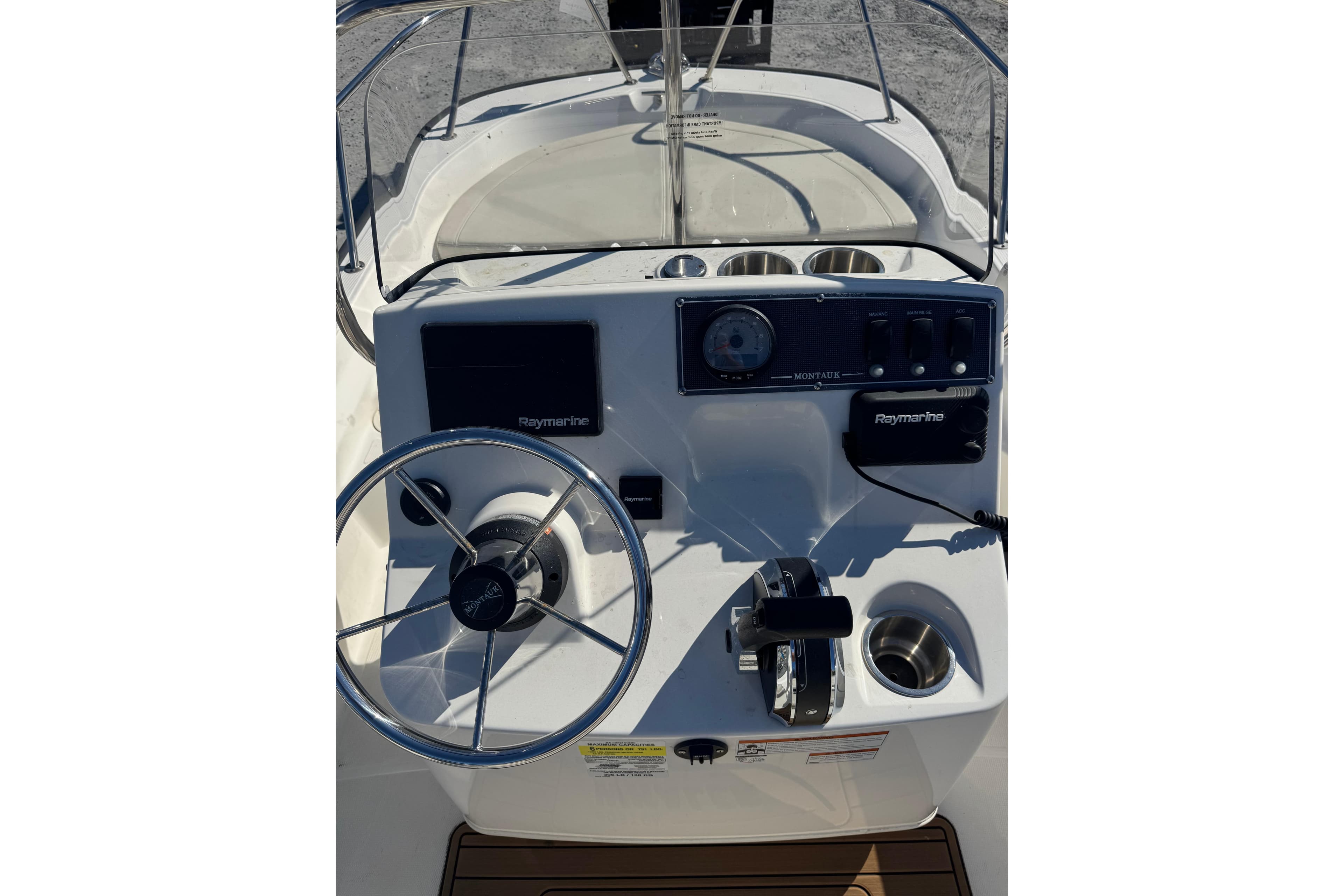 2022 Boston Whaler 150 Montauk boat console with steering wheel and Raymarine electronics.