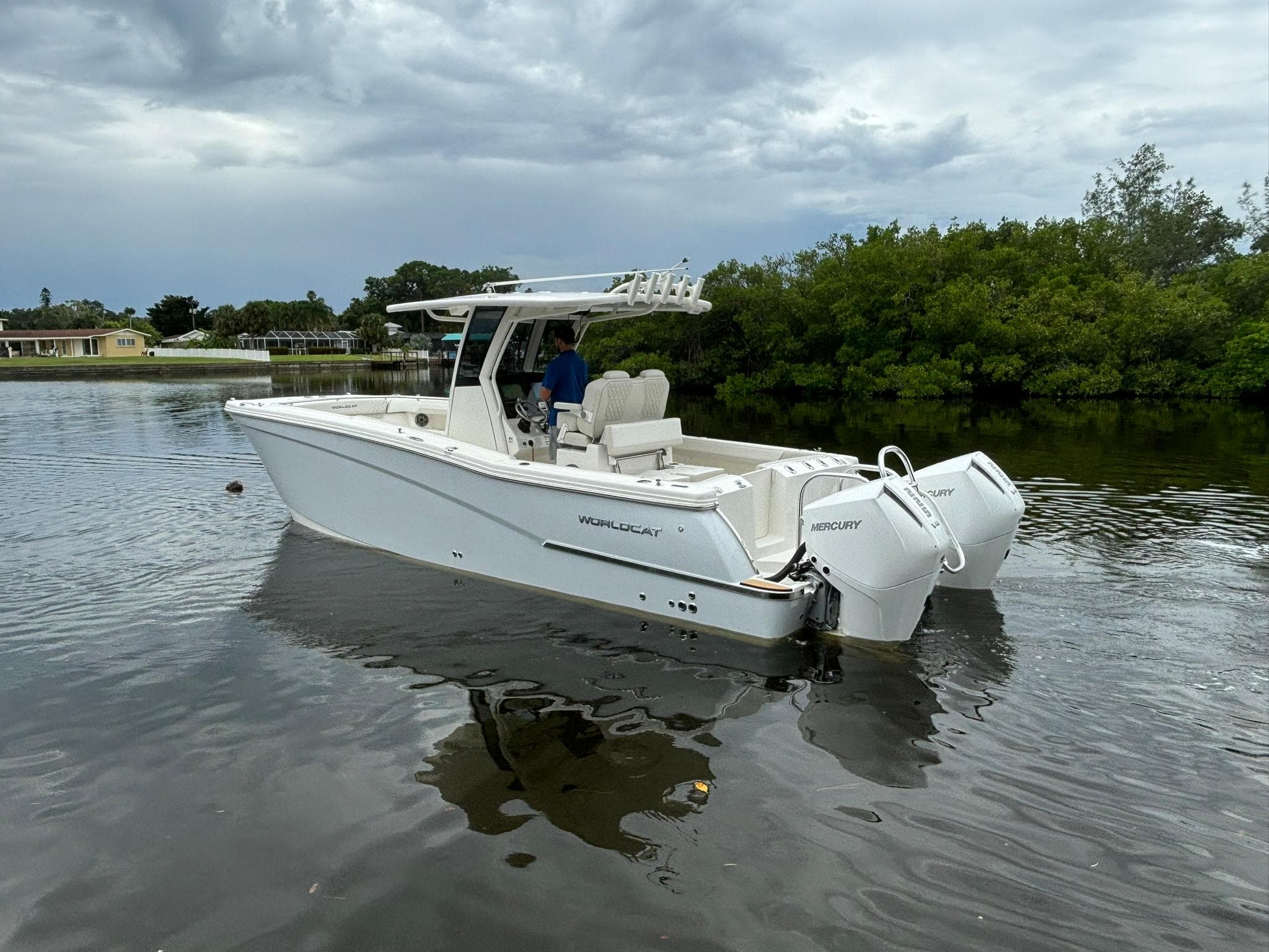 2025 World Cat 280 CC-X boat on calm water, featuring twin Mercury engines.