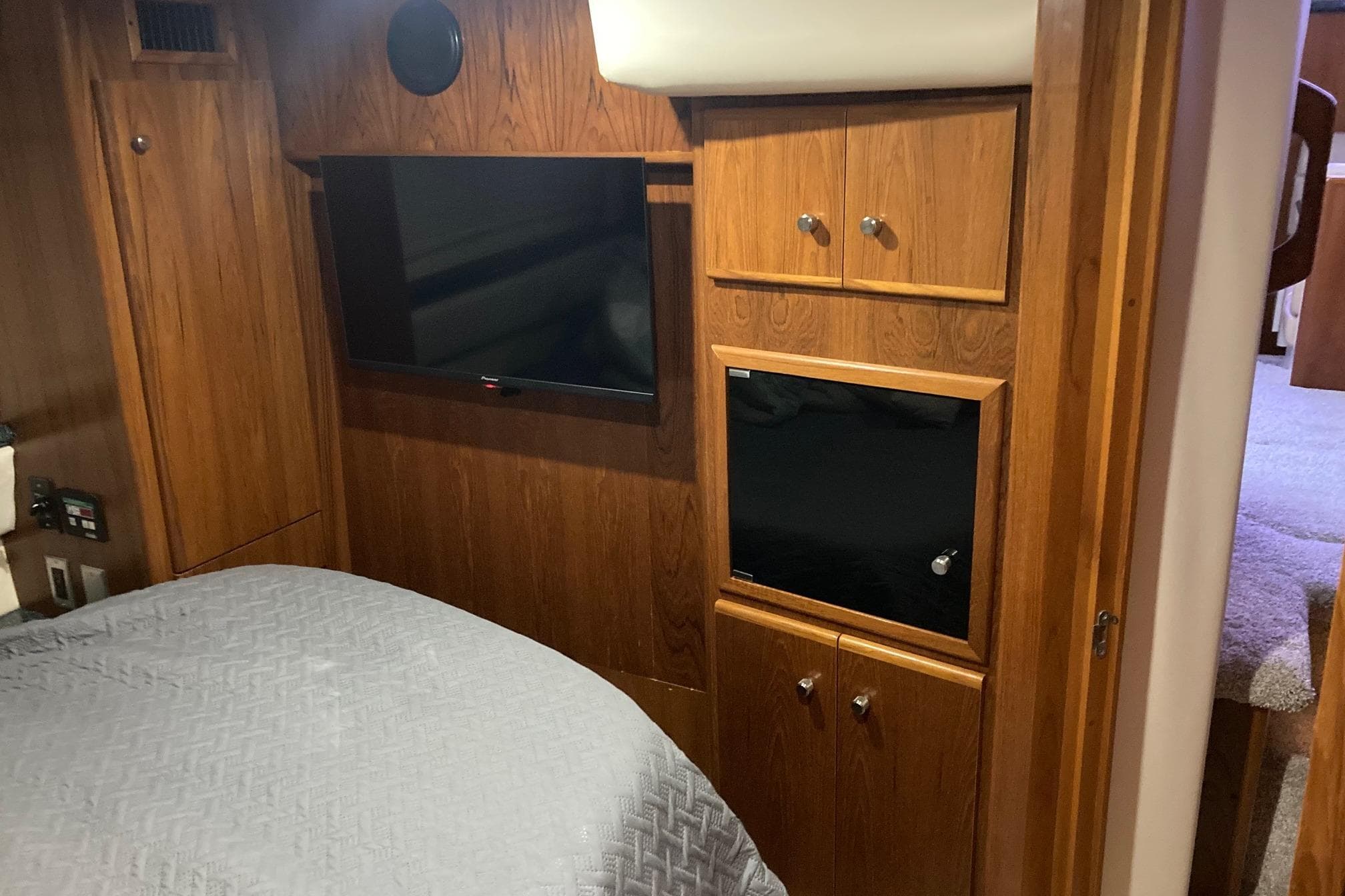 Interior of 2001 Carver 356 Motor Yacht with wood paneling and mounted TV.