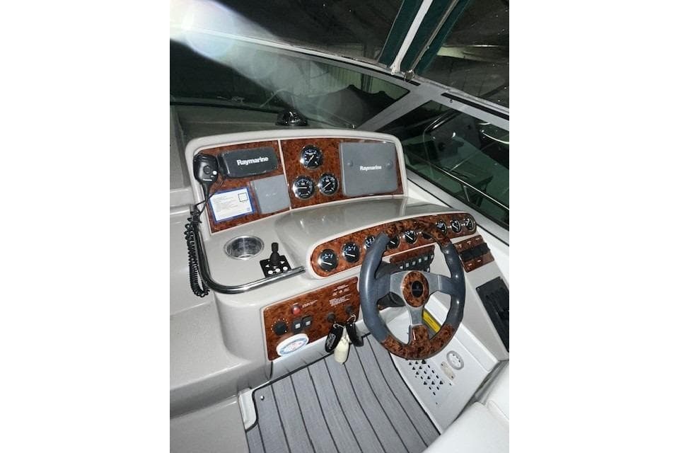 2004 Formula 34 Performance Cruiser helm with Raymarine electronics and woodgrain dashboard.