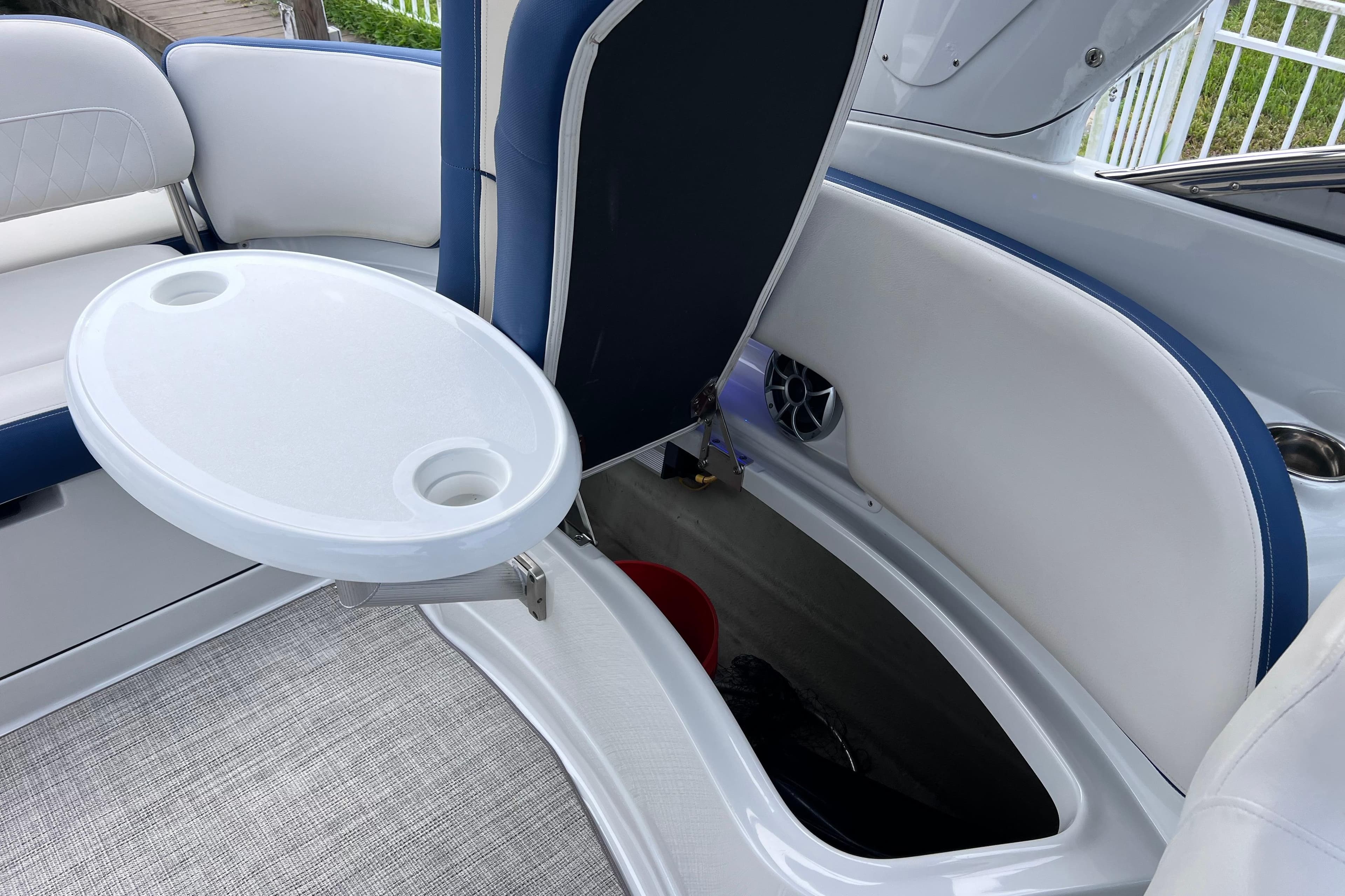 2022 Crownline 290 XSS boat interior with seating, storage, and table.