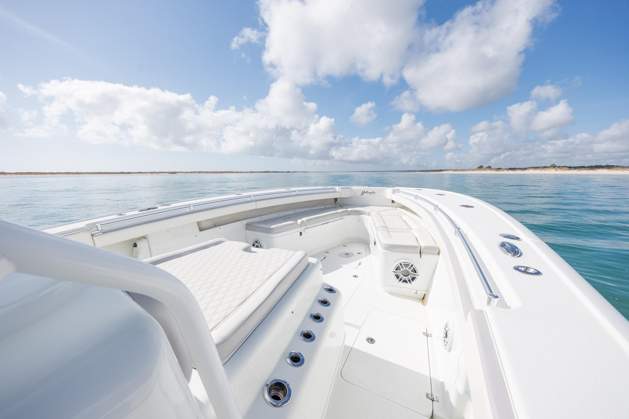 2014 Yellowfin 42 Offshore boat on calm sea under blue sky with clouds.