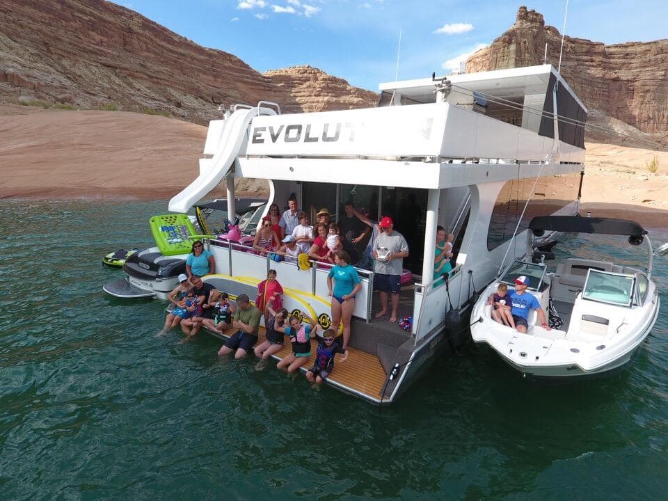 Group enjoying on 2015 Bravada Evolution Share #7 houseboat in scenic lake.