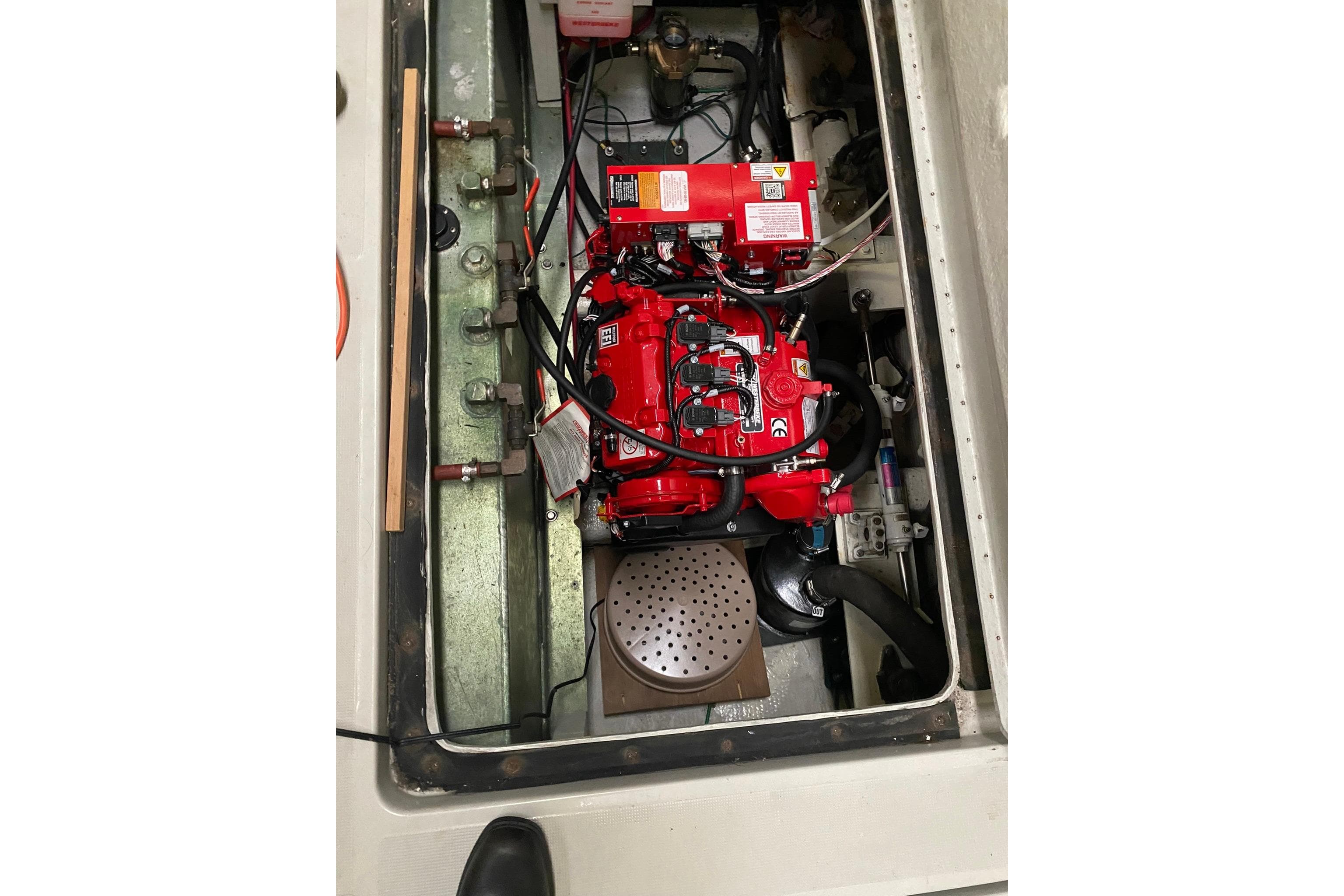 Engine compartment of a 1988 Tiara 3300 Open boat, featuring a red engine.