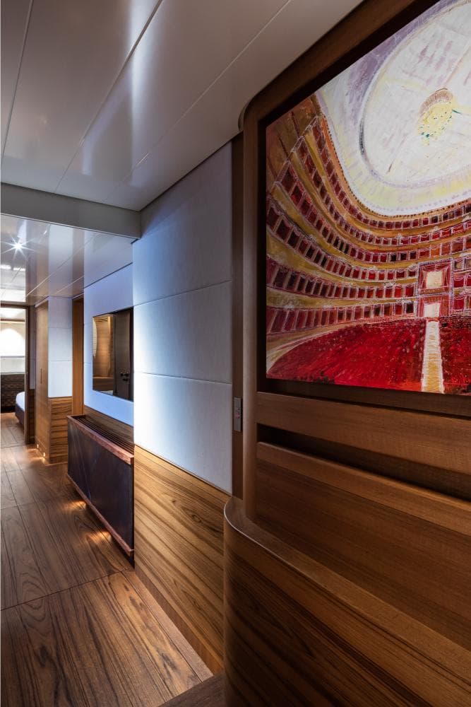 Luxurious interior of 2019 Baltic sailing yacht with elegant wood paneling and vibrant artwork.