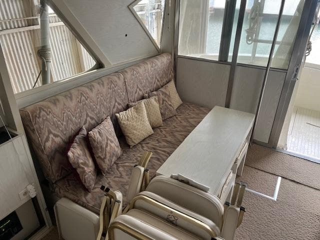 1970 Chris-Craft Commander Sport Cruiser interior with patterned sofa and cushions.