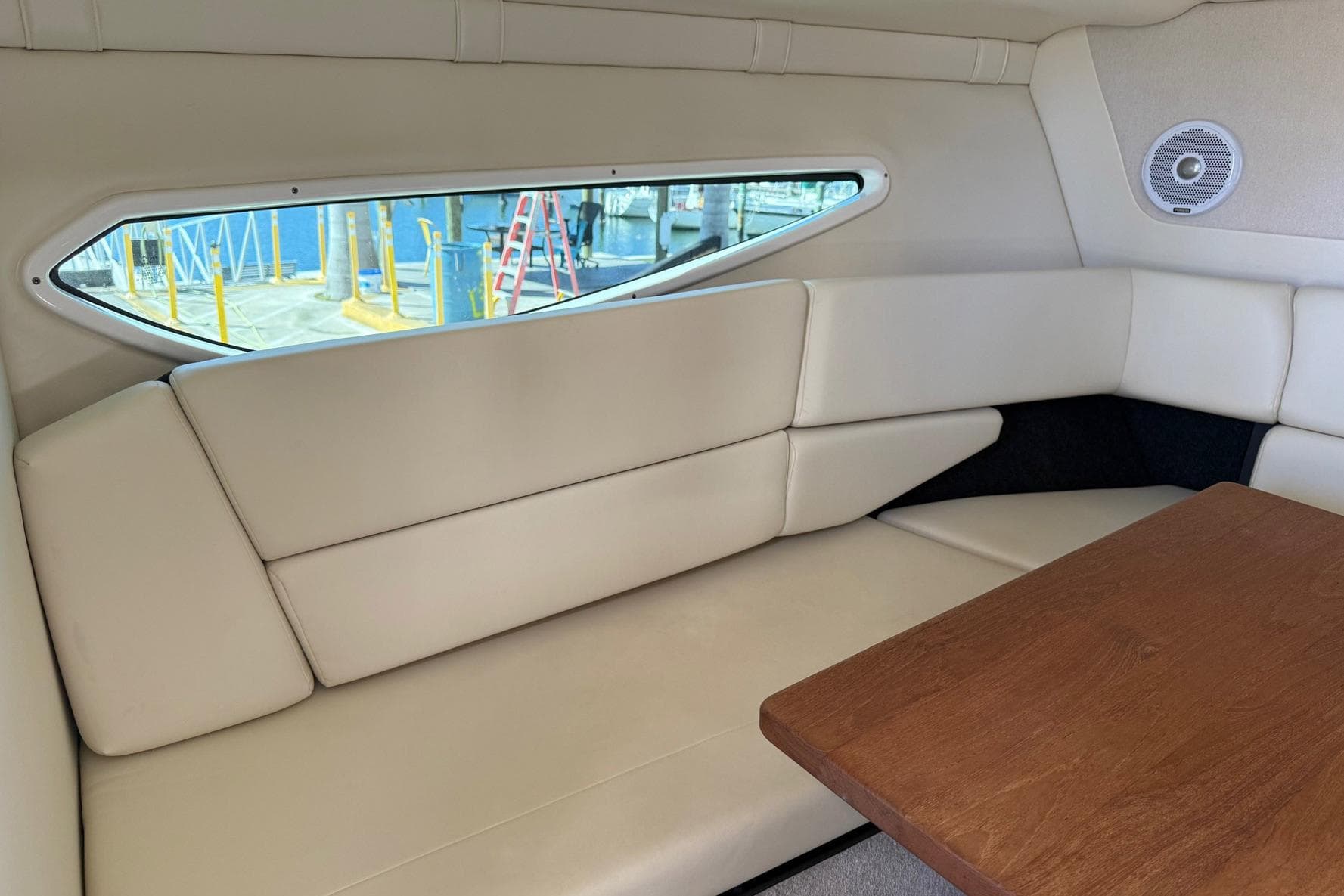 Interior of 2020 Regal 26 XO boat with beige seating and wooden table.