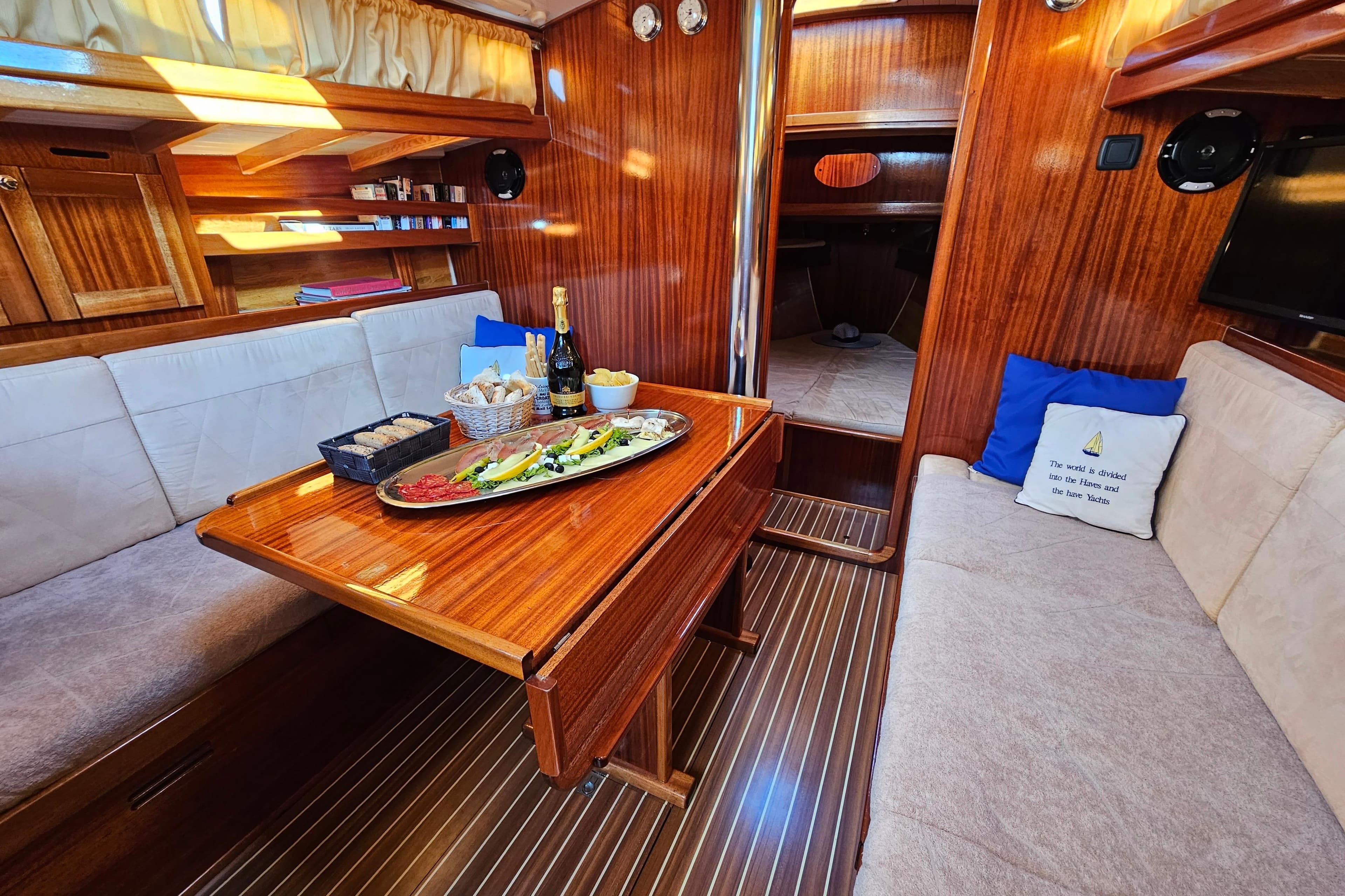 Luxurious 2008 CUTTER ENAVIGO yacht interior with elegant dining setup and wooden finishes.