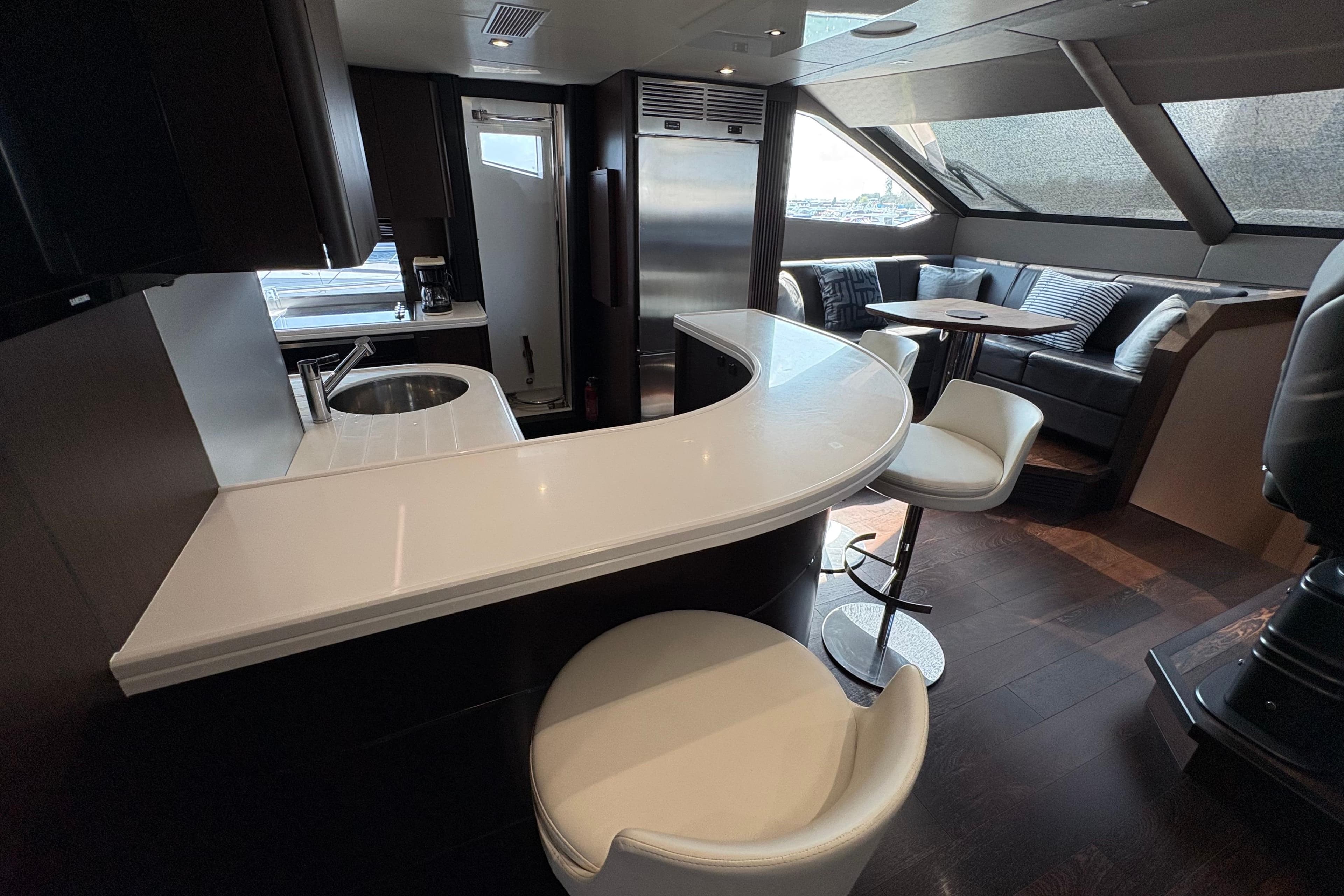 Luxurious interior of 2018 Sunseeker 86 Yacht with modern bar and seating area.