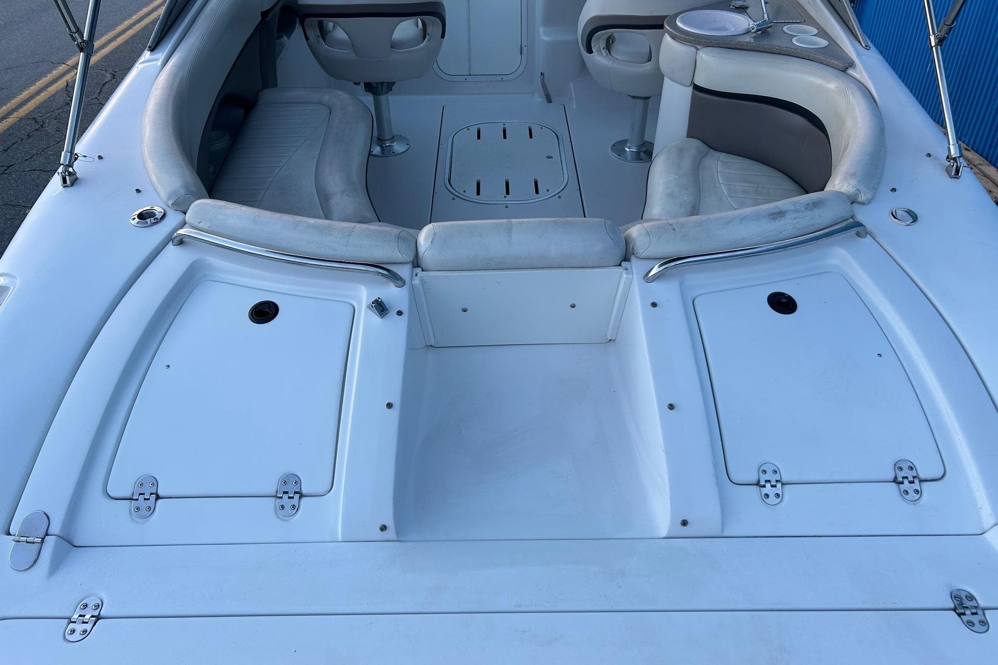 2003 Four Winns 225 Sundowner boat interior with seating and storage compartments.
