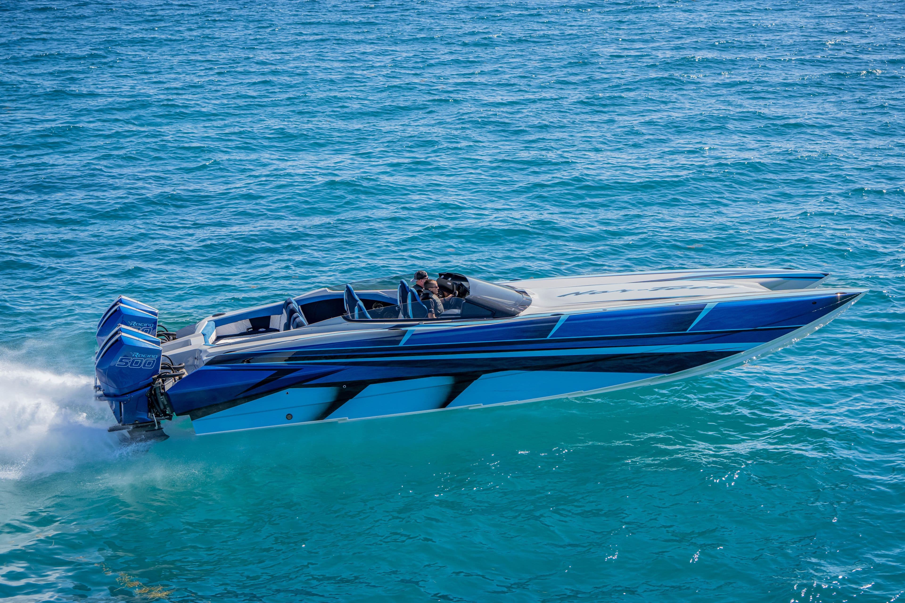 2026 Nor-Tech 4000 Super Catamaran speeding on clear blue ocean waters.