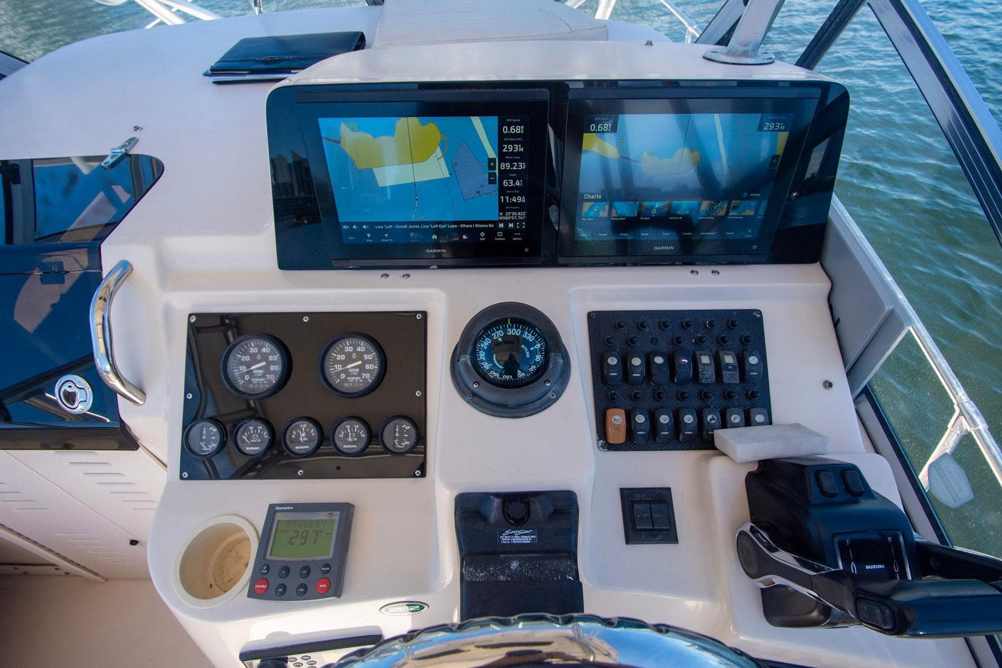 Control panel of a 2004 Grady-White Sailfish 282 boat with navigation screens and gauges.