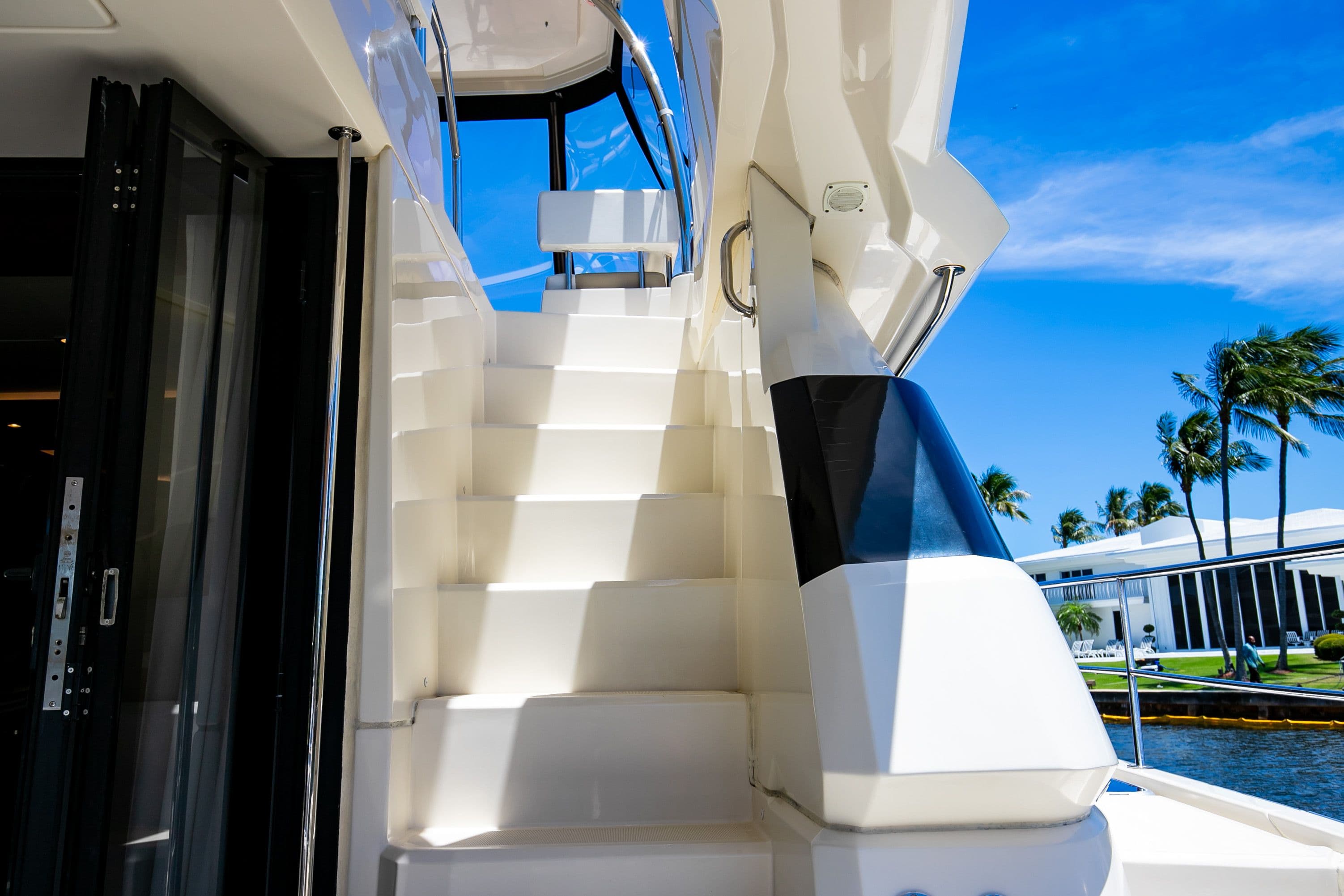 Staircase on a 2017 Aquila 44 Yacht under sunny skies.