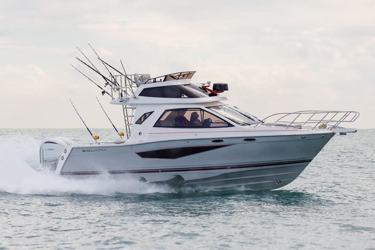Manufacturer Provided Image: 2026 Solara S-310 SB boat cruising on open water, equipped with fishing rods.