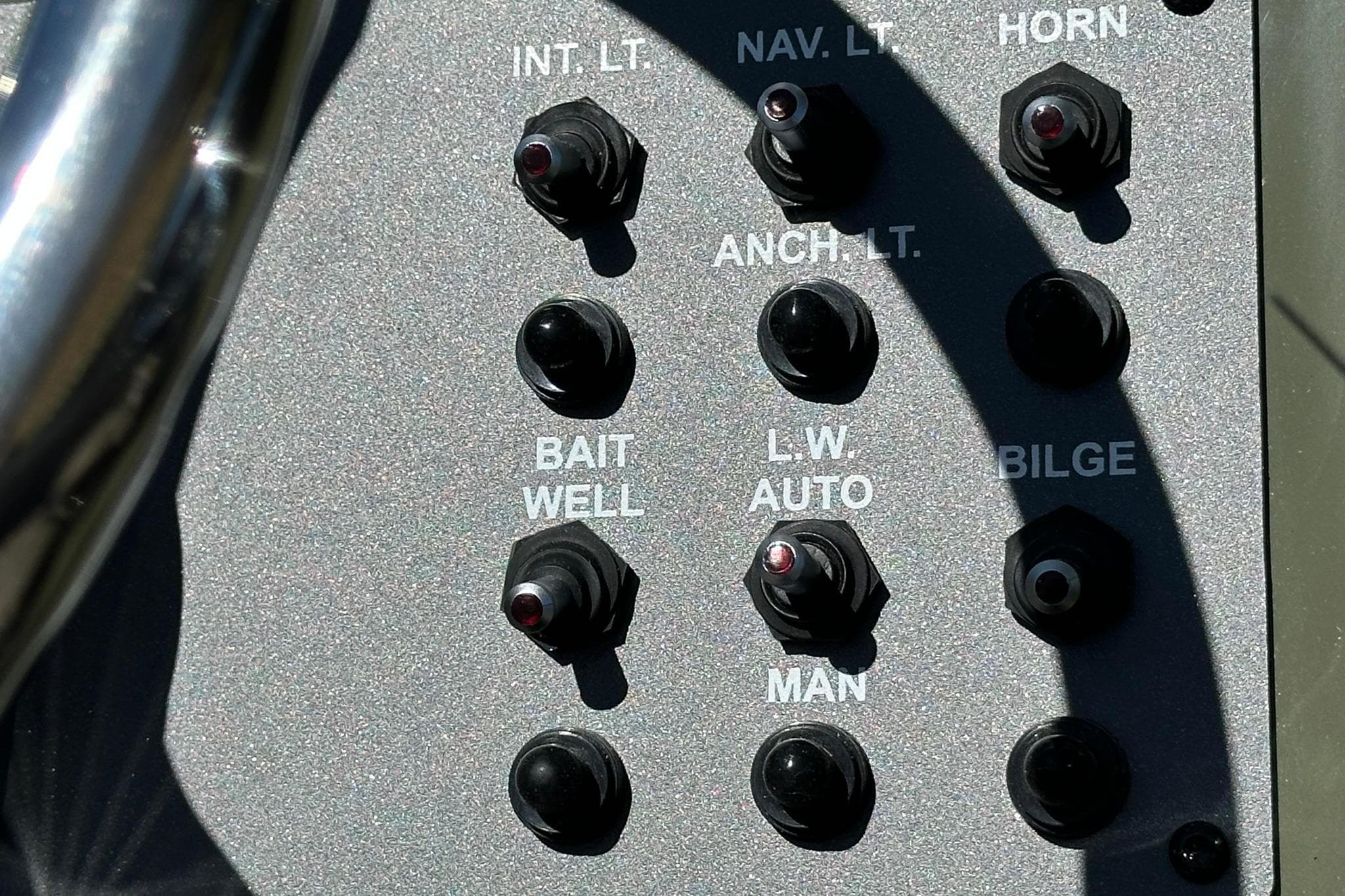 Control panel of 2026 Vexus ACX 2000 boat with various switches.