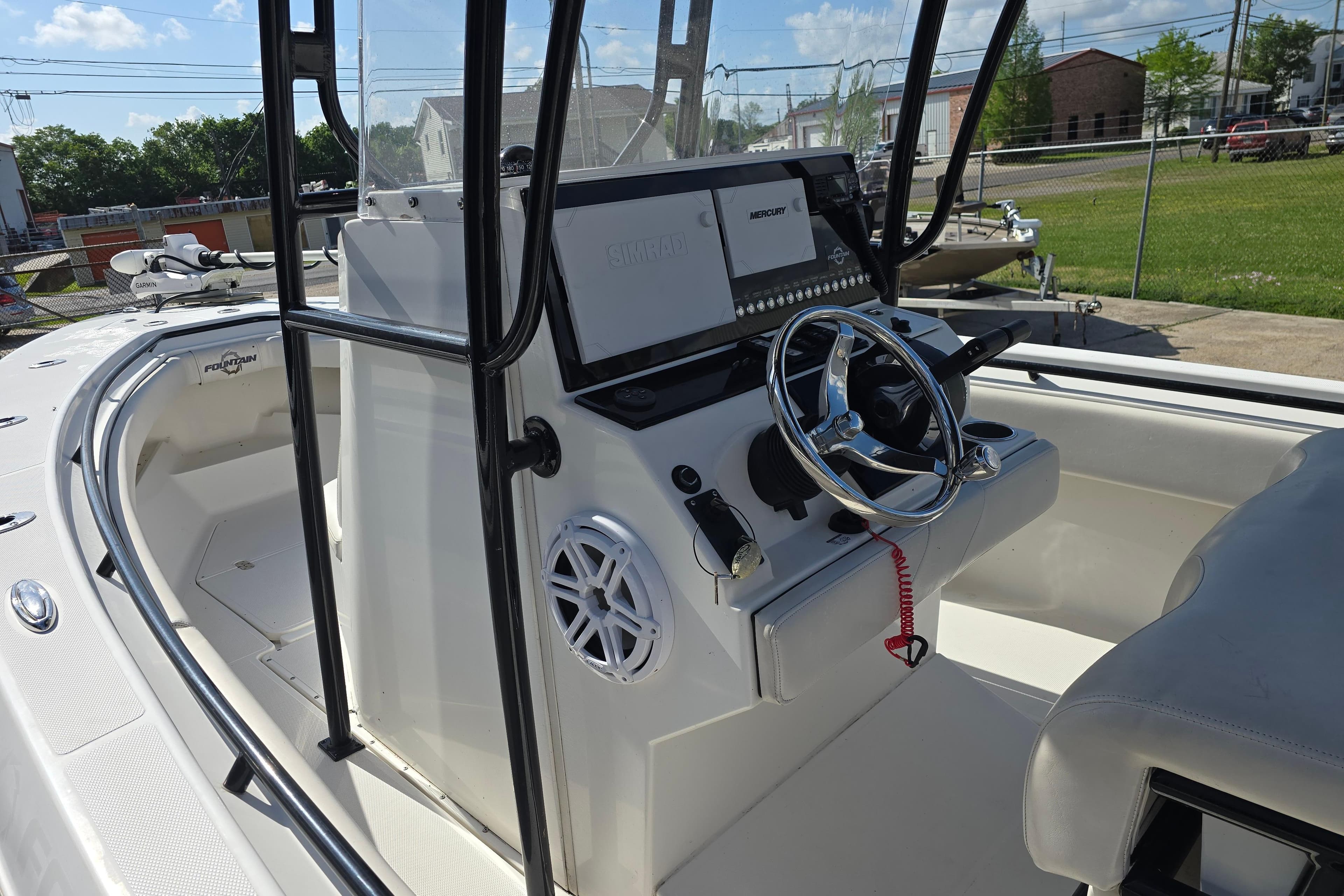 2006 Fountain 23 Center Console boat interior with steering wheel and control panel.