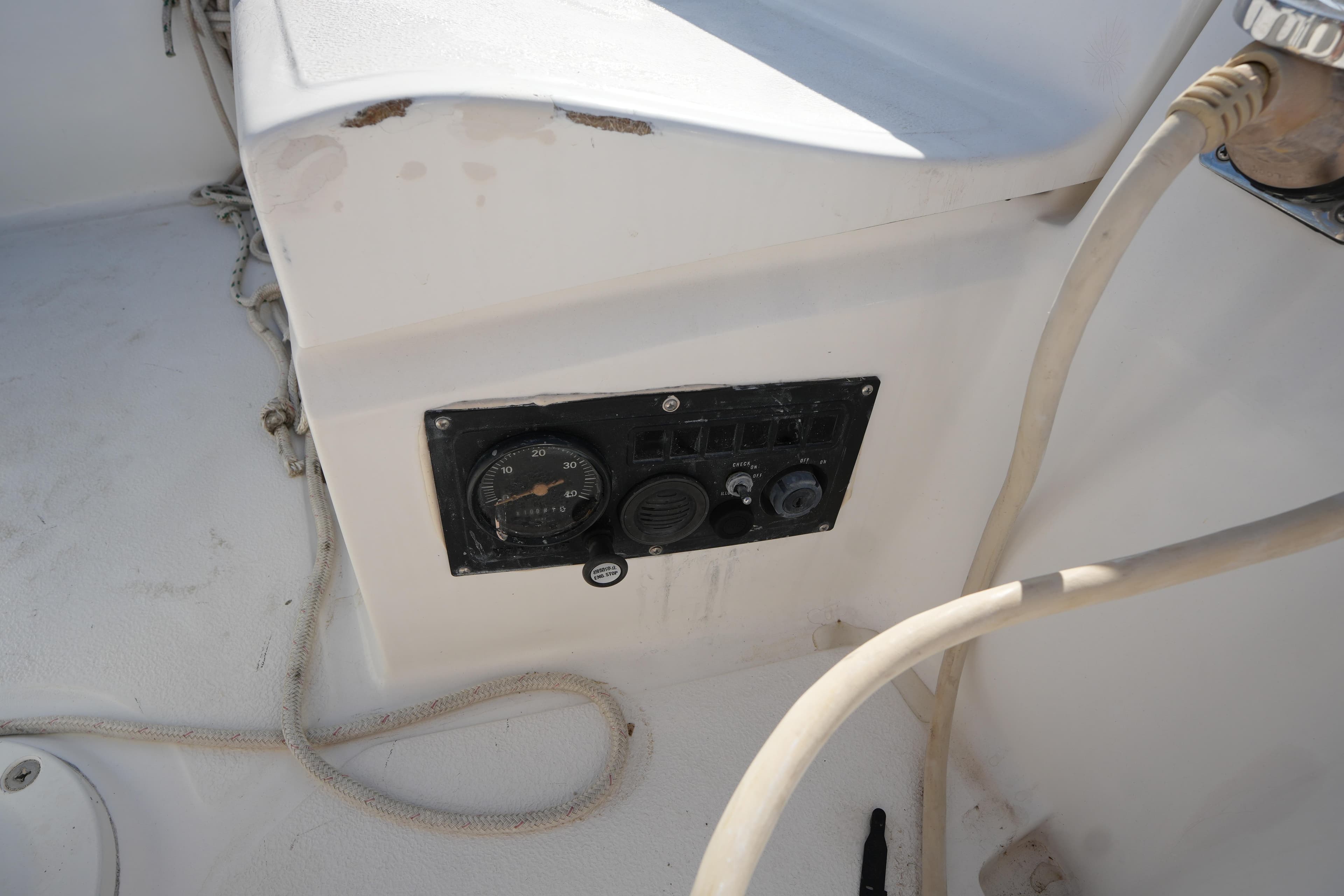 Control panel on a 1986 Hunter 28.5 sailboat, featuring gauges and switches.
