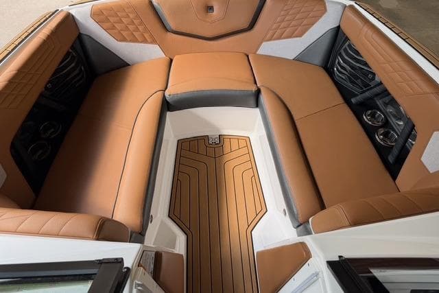 Luxurious interior of 2023 Nautique Super Air Nautique G23 boat with tan seating.