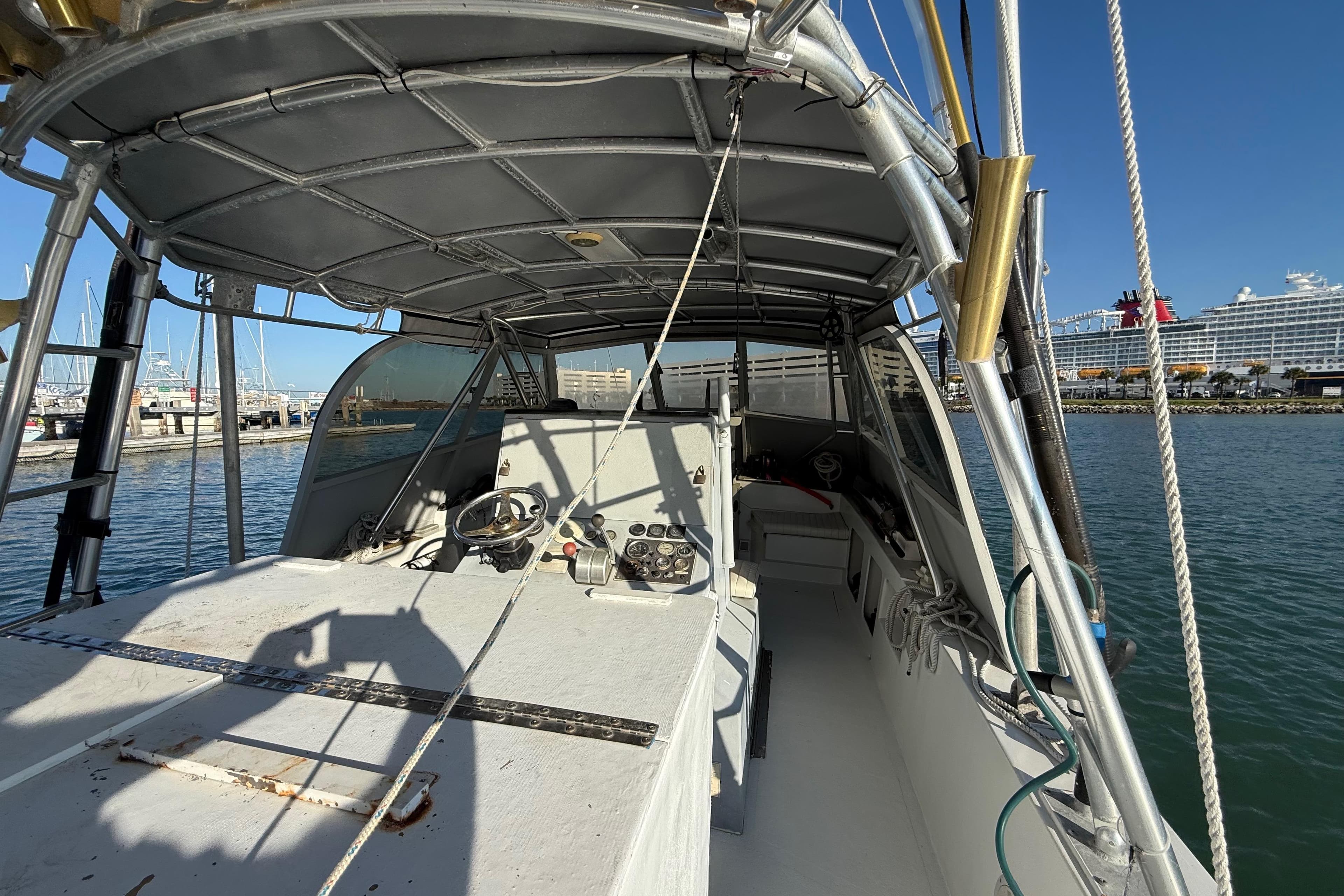 1988 Stuart Angler 32 boat interior with steering wheel, docked at marina.