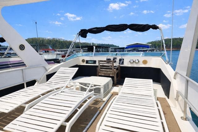 1987 Sumerset 14x64 houseboat deck with lounge chairs and scenic lake view.