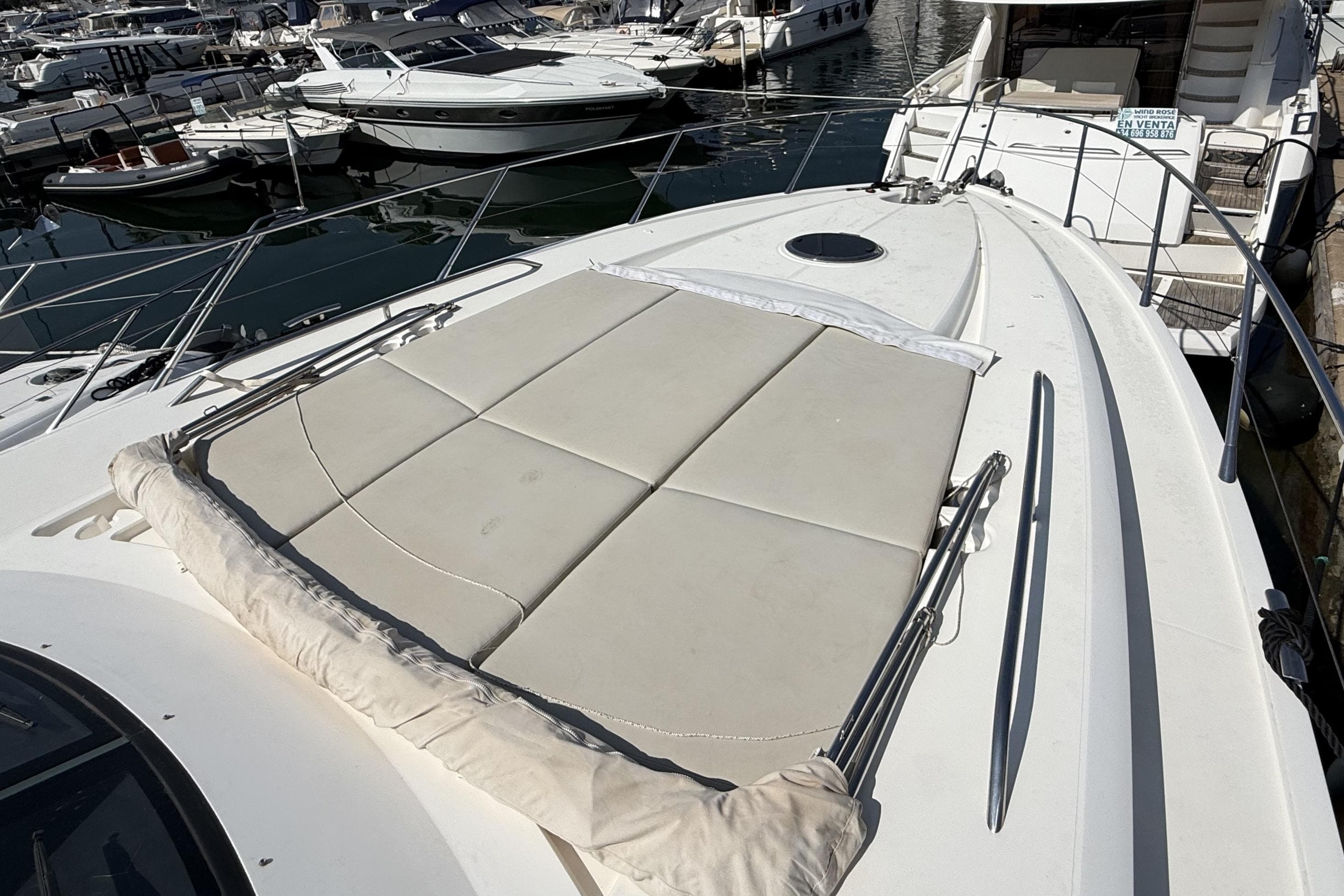 Sunseeker Predator 60 yacht, 2012 model, docked with sunbathing area on deck.