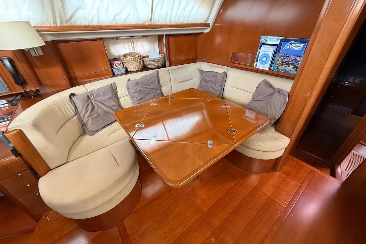 Luxurious Moody 47 yacht interior with elegant wood finish and cozy seating, 2002 model.
