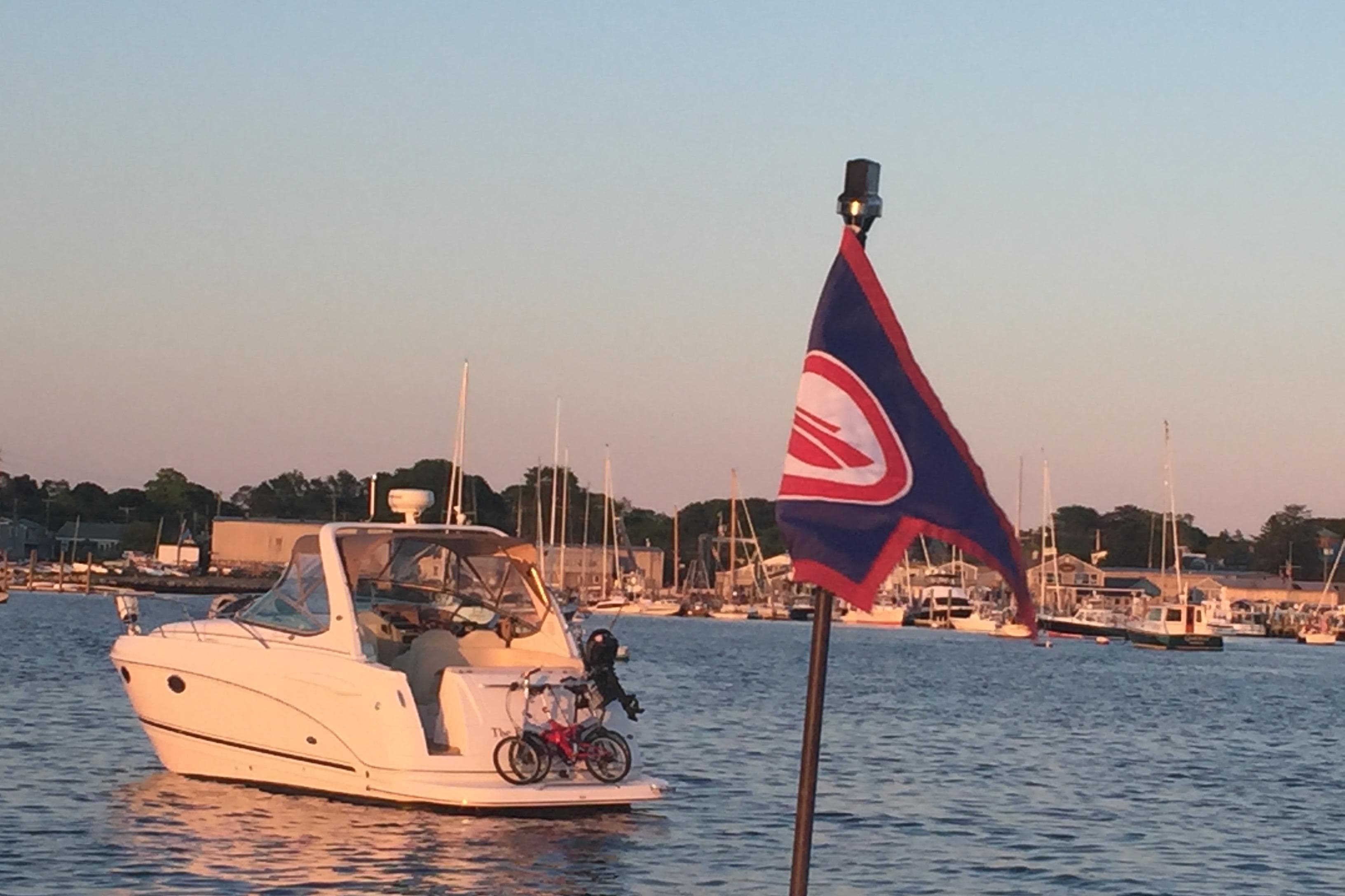 2005 Chaparral 290 Signature boat on water with flag and bicycles onboard.