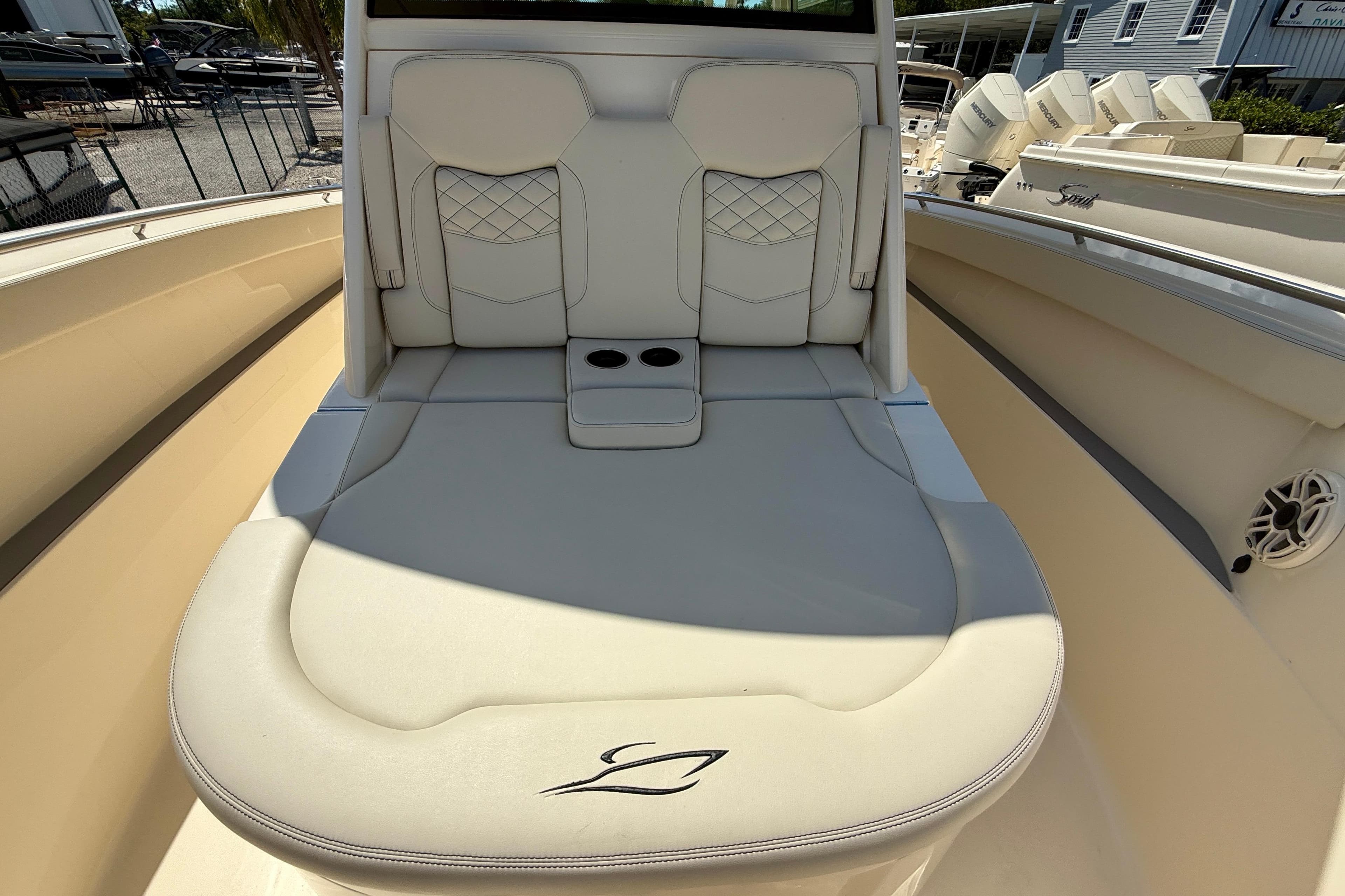 Luxurious seating on 2026 Scout 330 LXF boat, featuring elegant design and cup holders.