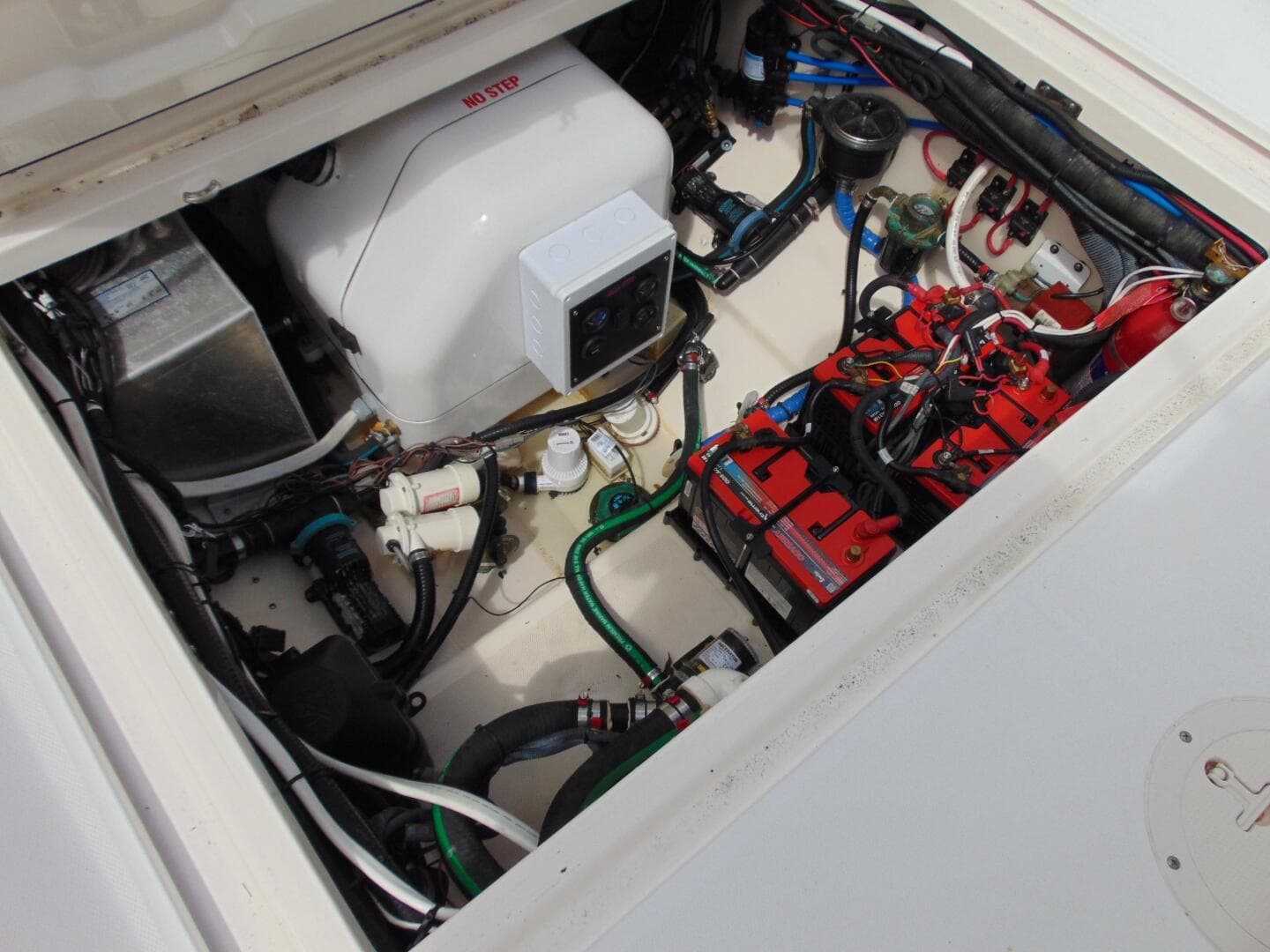 Engine compartment of 2013 Boston Whaler 370 Outrage, showcasing mechanical components and wiring.