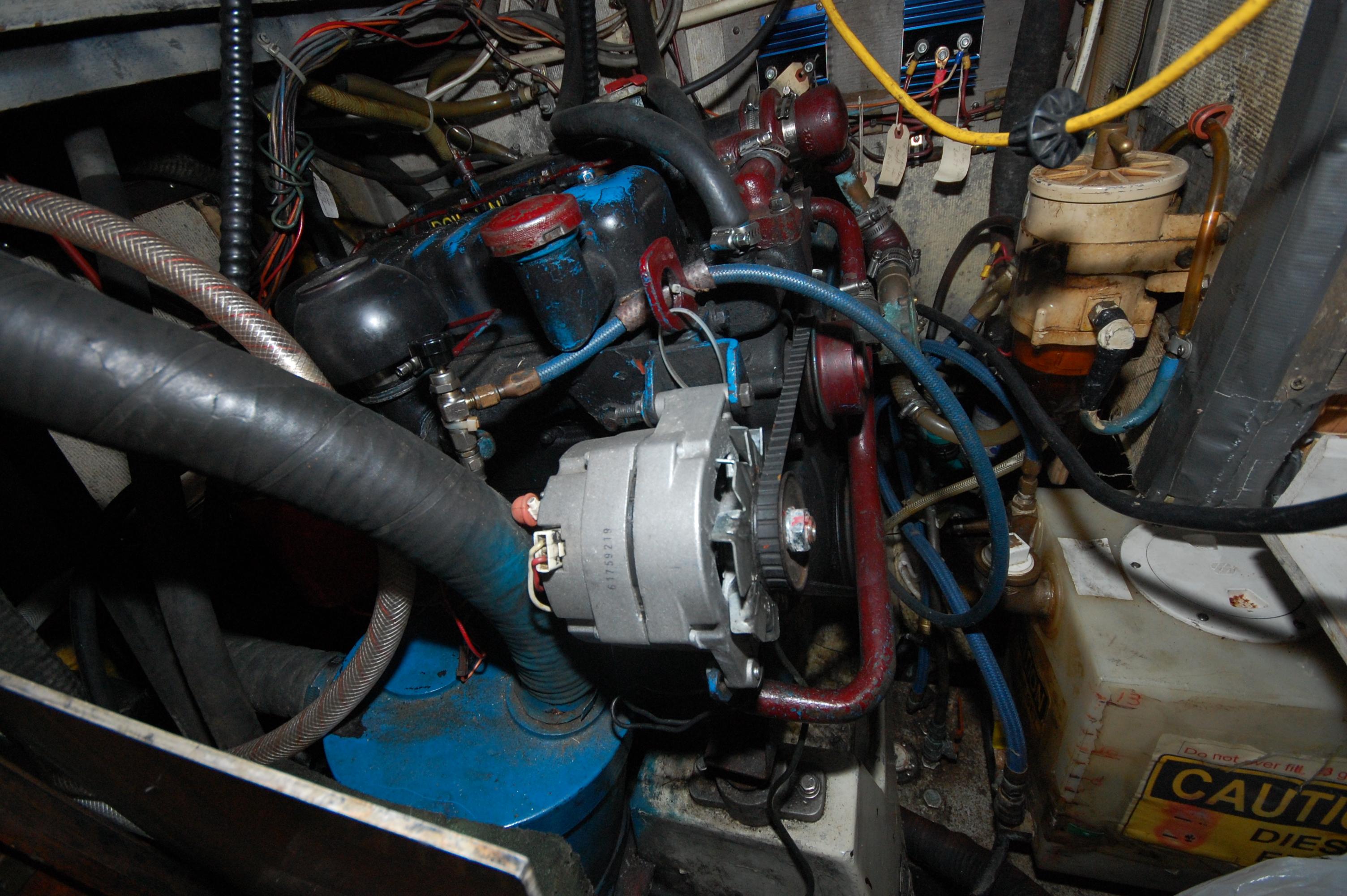 Engine compartment of a 1981 Endeavour 40 sailboat, showcasing mechanical components and wiring.