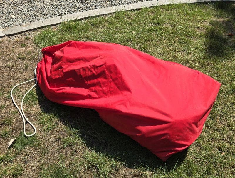 Red sail bag on grass, associated with 1993 Freedom Cruising sloop.