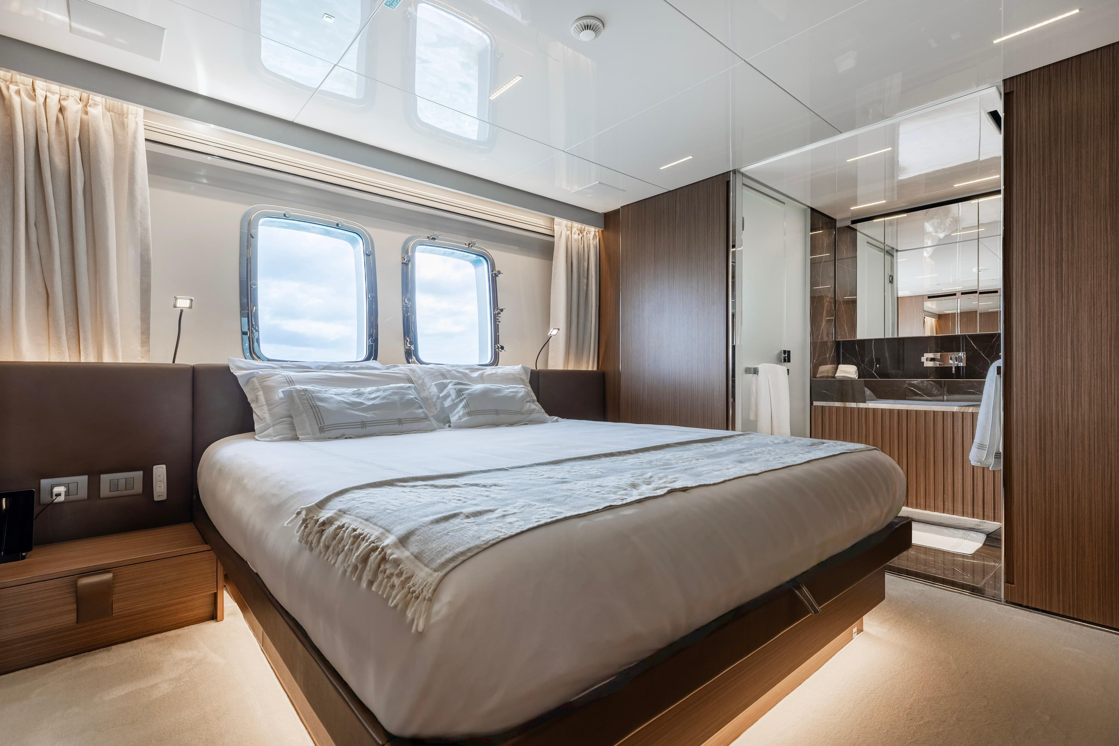 Luxurious bedroom interior of 2022 Sanlorenzo SL120A yacht with modern design and large windows.