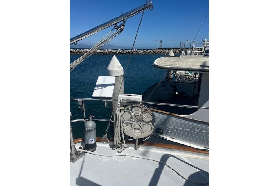 1986 Liberty 49 yacht docked at marina with clear blue sky.