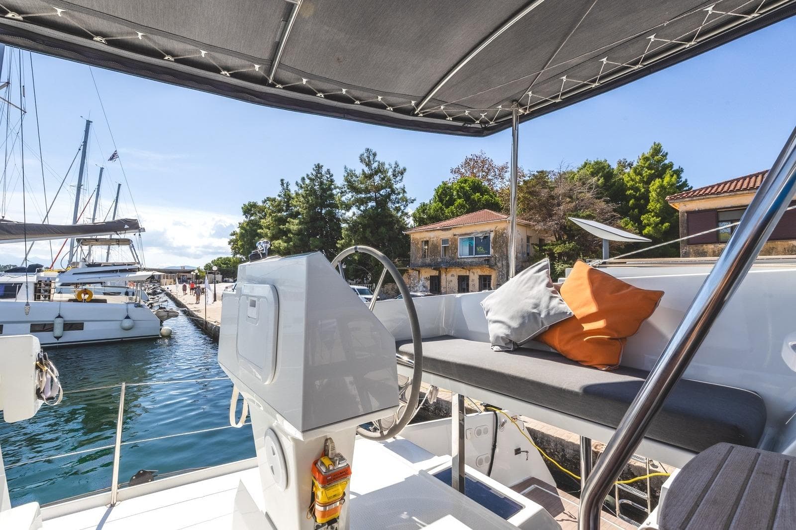 2023 Fountaine Pajot Astrea 42 Maestro yacht docked, featuring helm and seating area.