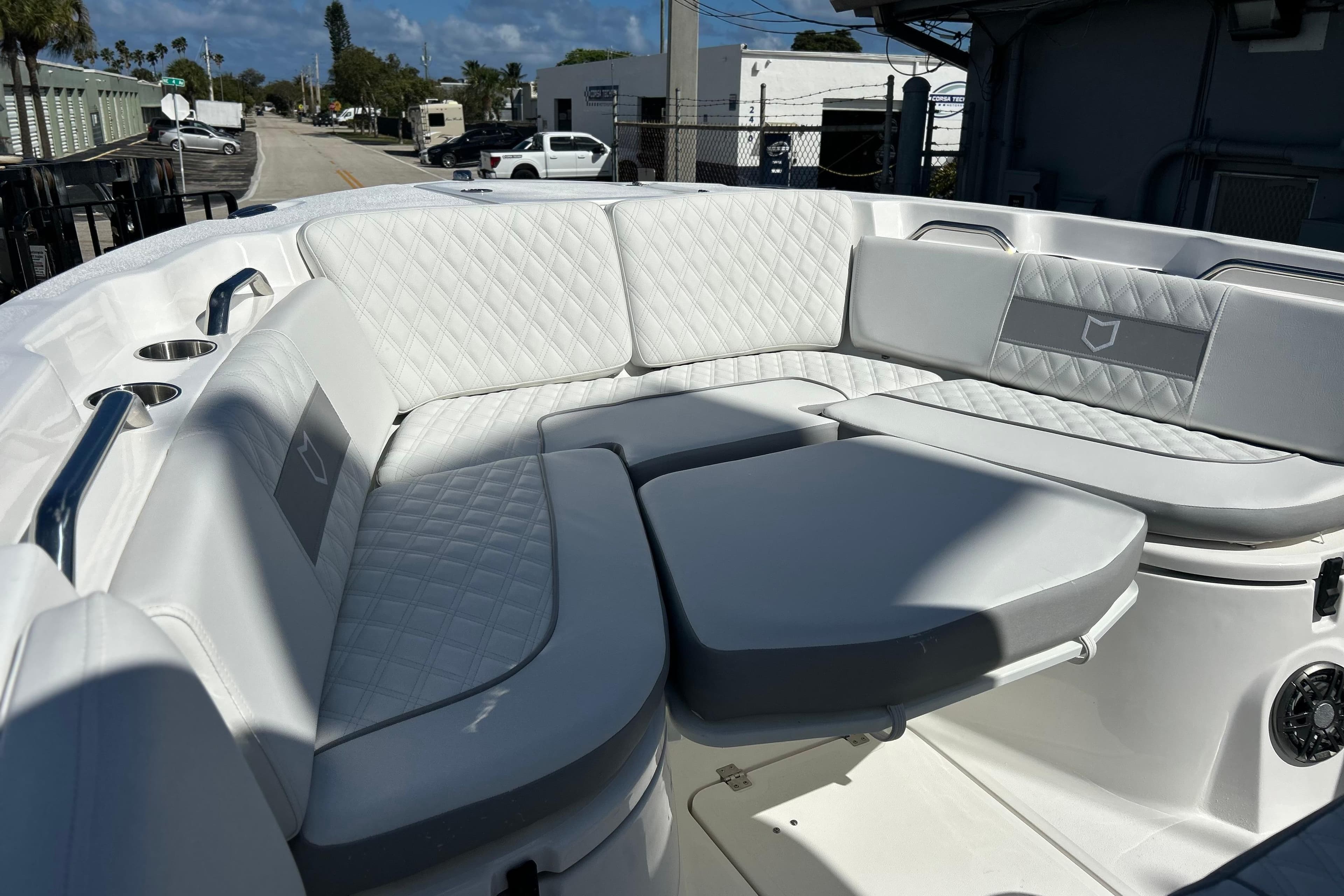 2026 Sea Fox 268 Commander boat interior with luxurious white seating and cup holders.