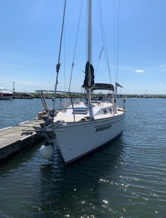 1983 Gulfstar 36 sailboat docked in sunny marina.